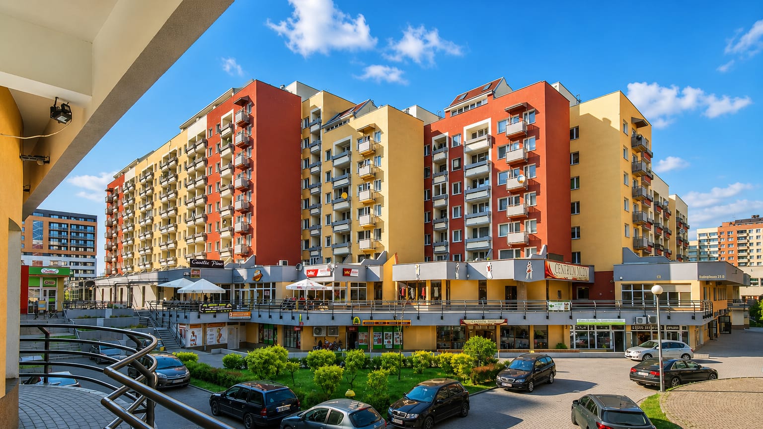 Street-level view of a colourful modern housing and retail estate in the Gądów Mały district of Wrocław.