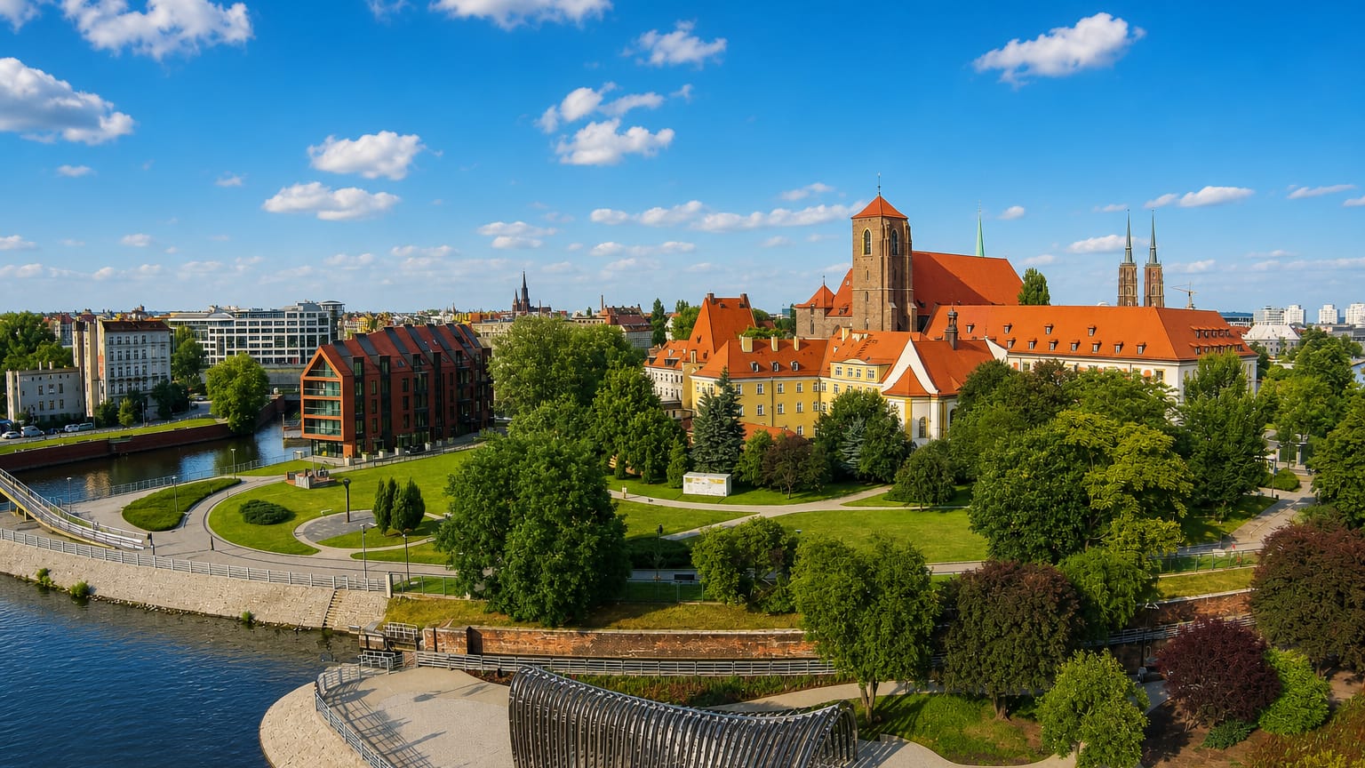 Wroclaw's Ostrow Tumski with red-brick Gothic churches and townhouses along the Oder river amid greenery