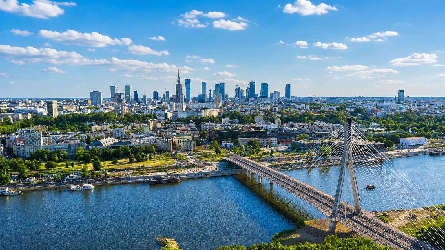 Warsaw skyline across the Vistula with the Palace of Culture spire, modern towers and the Swietokrzyski bridge