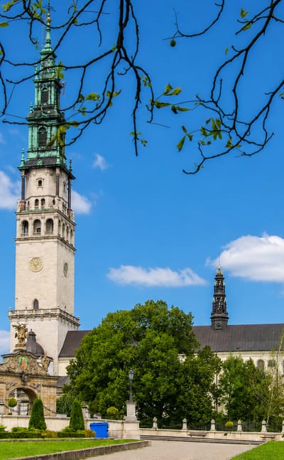 Jasna Góra Monastery in Częstochowa, its Baroque tower and green spire rising above manicured gardens.