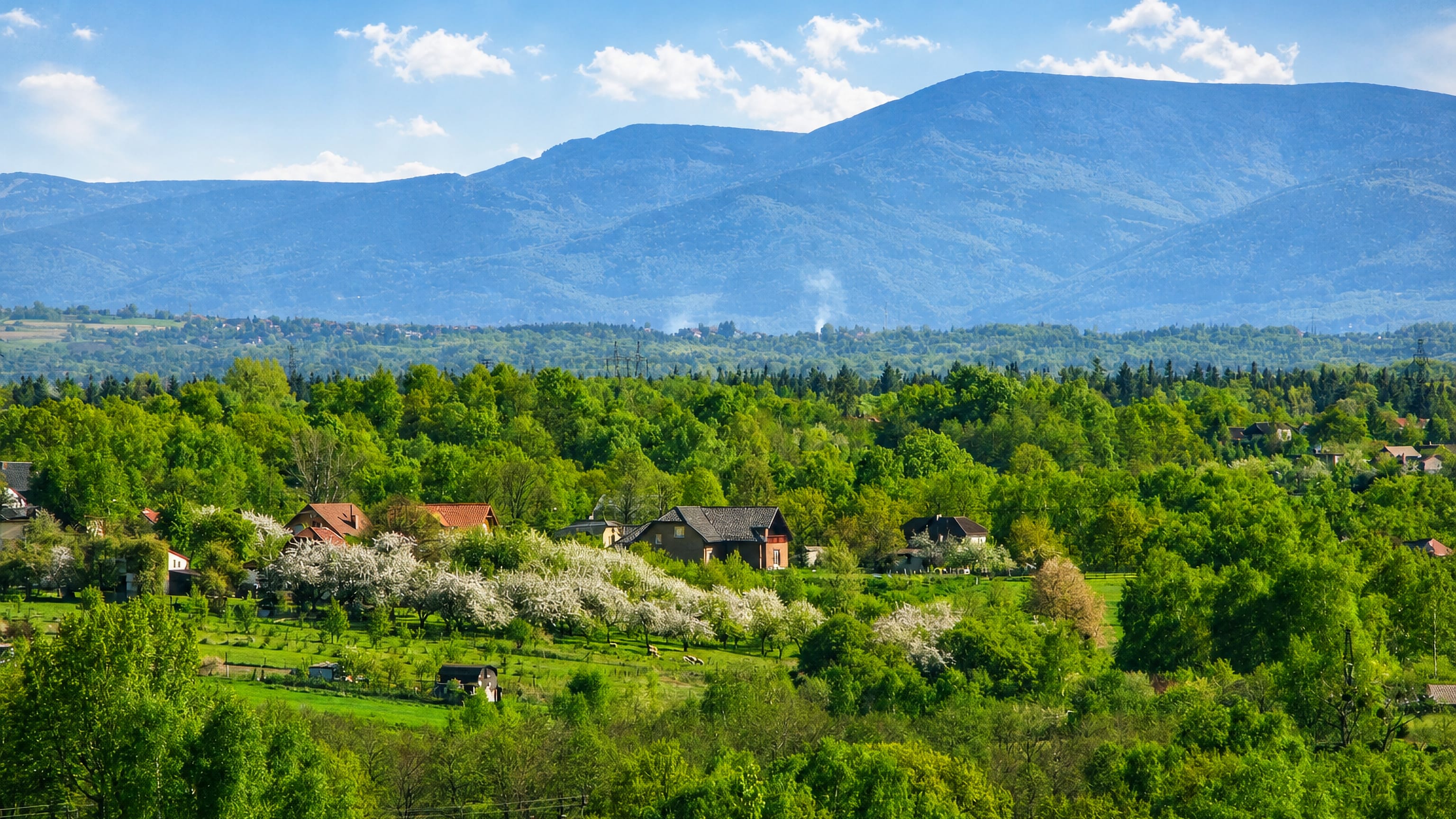 Blossoming orchards and scattered houses below the Beskid mountains in Ruptawa, Jastrzebie-Zdroj.