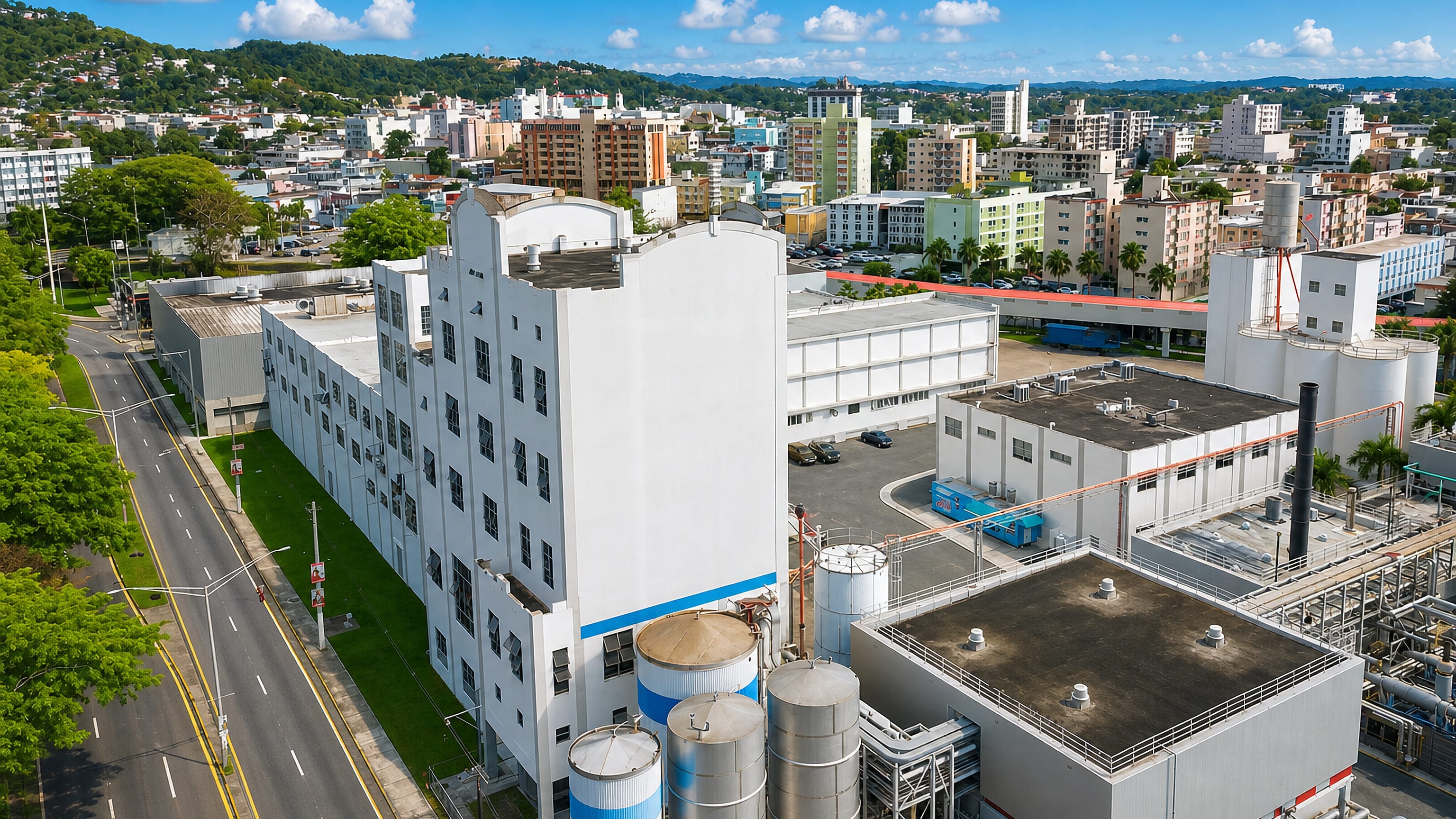 Aerial view over an industrial plant and hillside apartment blocks in Mayaguez, Puerto Rico