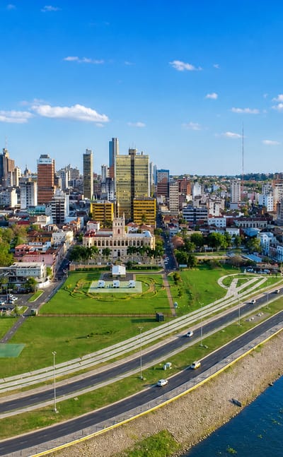 Asuncion's waterfront park and skyline with the white Palacio de los Lopez by the Paraguay River.