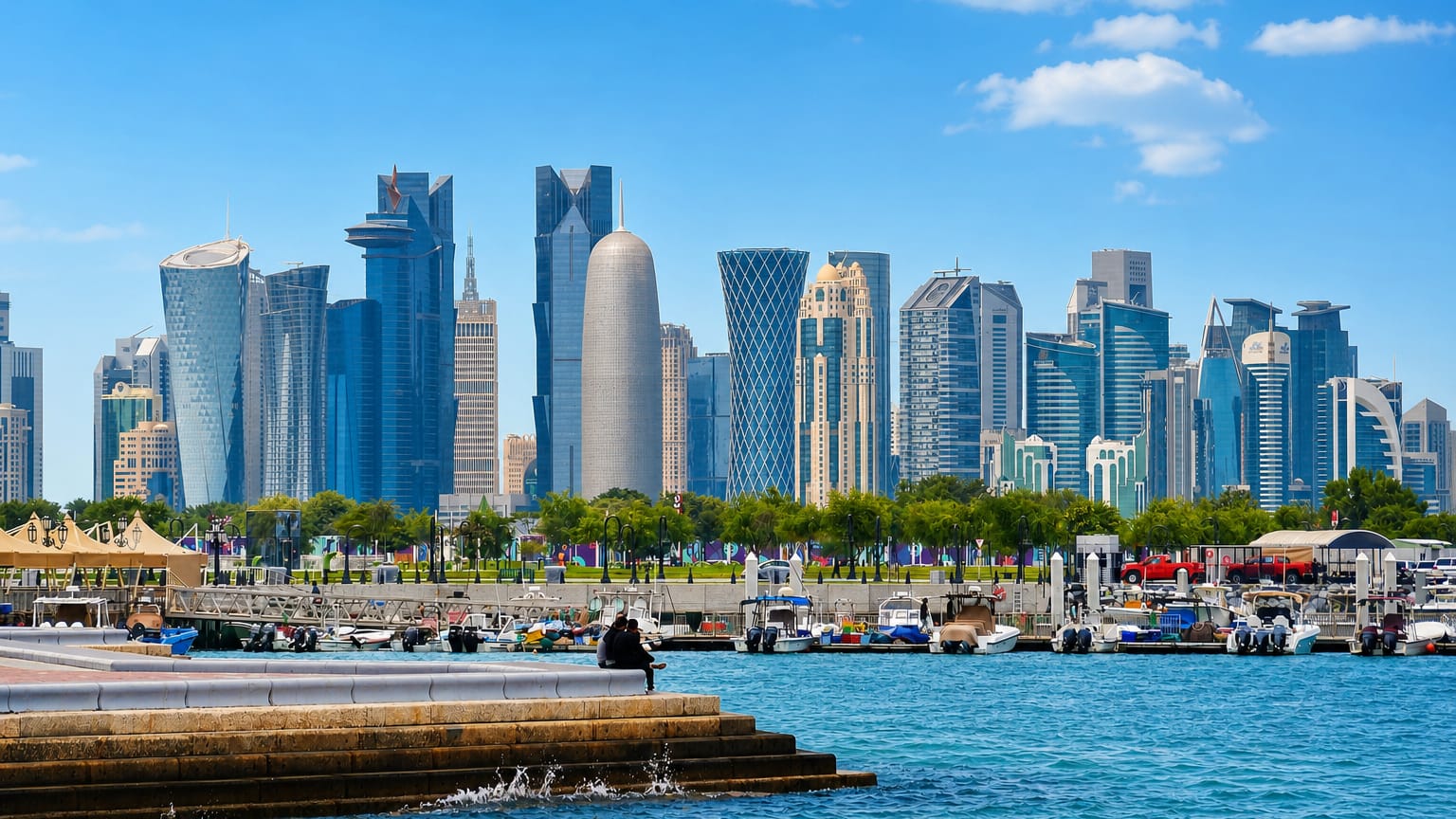 Doha's West Bay skyline of glass towers rising beyond a marina of moored boats along the Corniche.