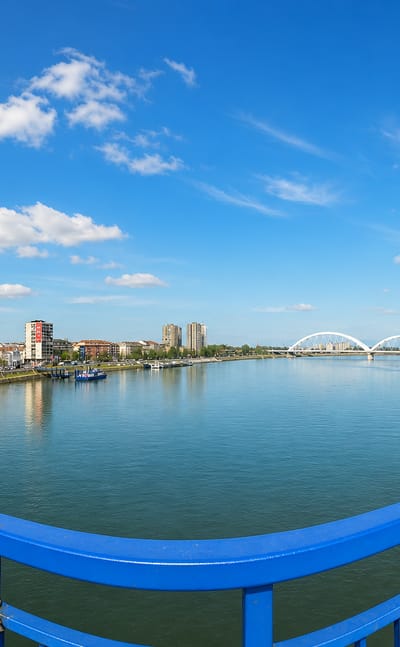 The Danube at Novi Sad seen from a bridge with the white arched Zezelj Bridge in the distance