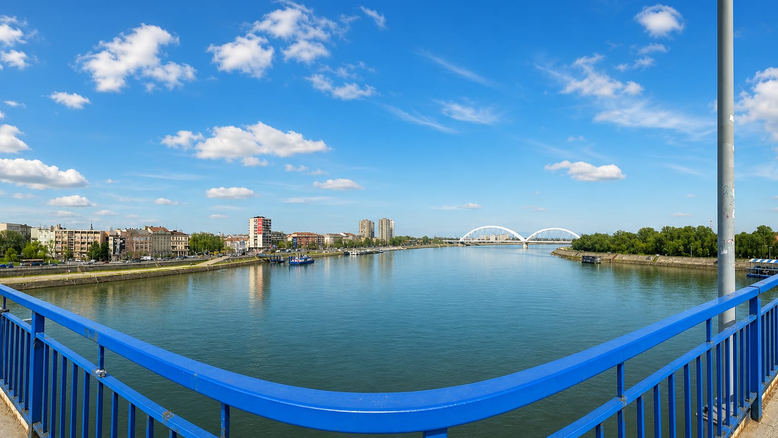 The Danube at Novi Sad seen from a bridge with the white arched Zezelj Bridge in the distance