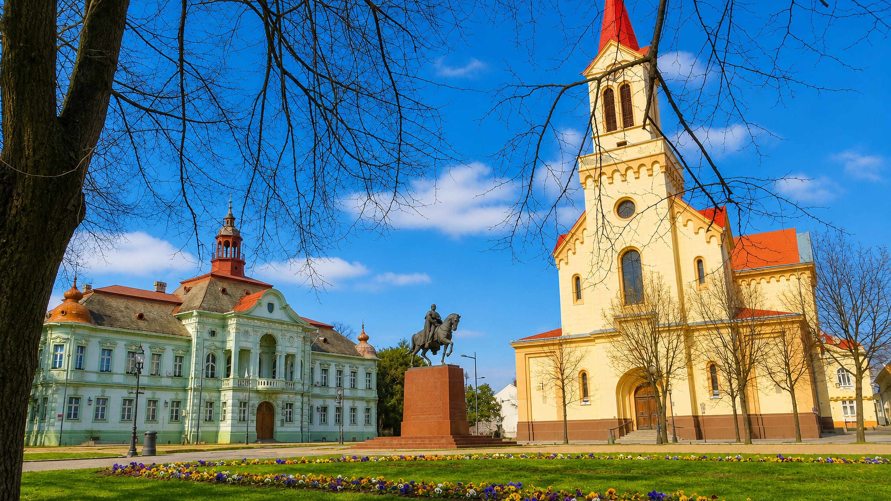 Zrenjanin's yellow cathedral, Baroque city hall and King Peter I equestrian statue on the main square, Serbia.