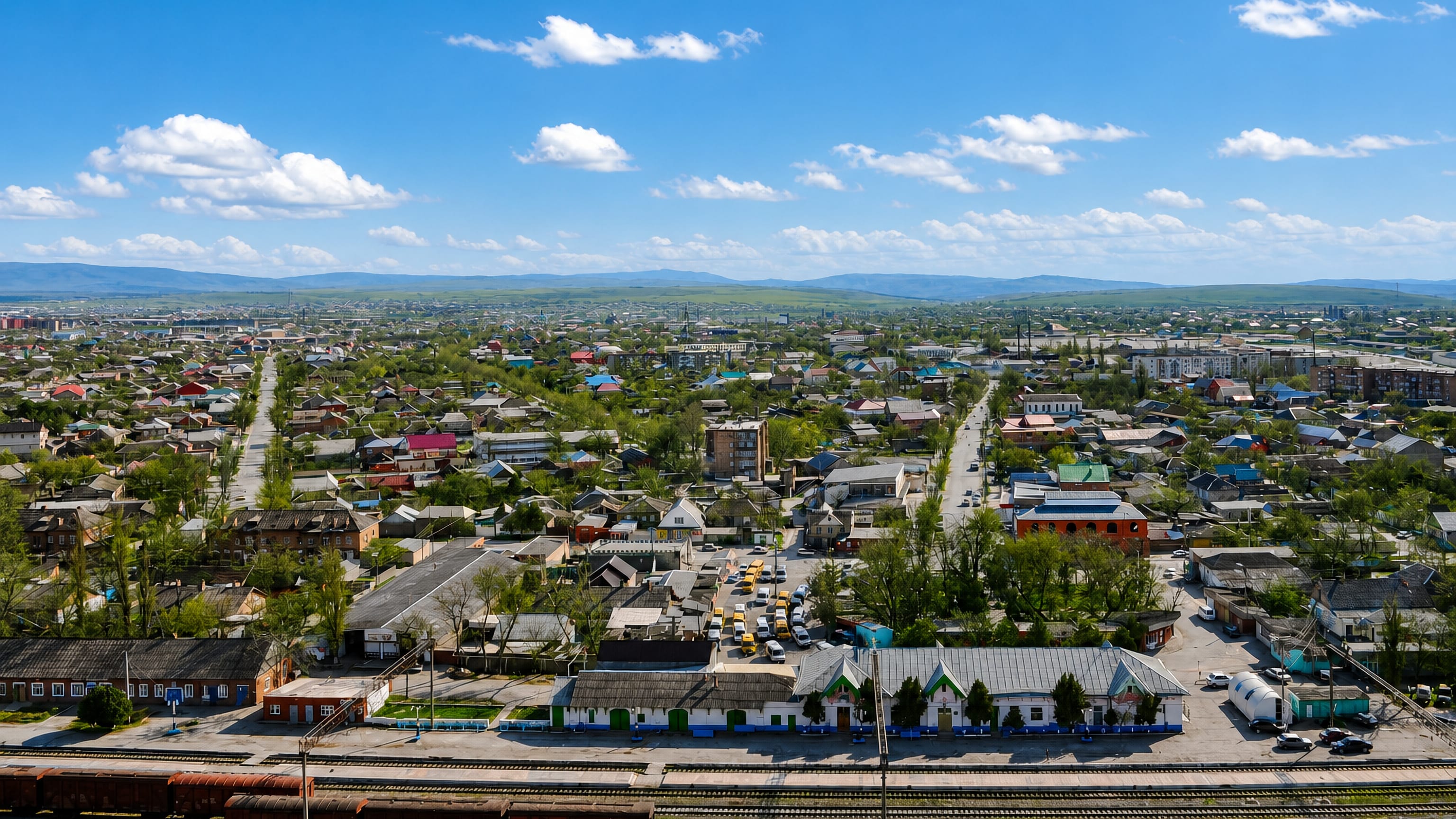 Aerial view of Khasavyurt, Dagestan, with its railway station in the foreground and Caucasus foothills behind