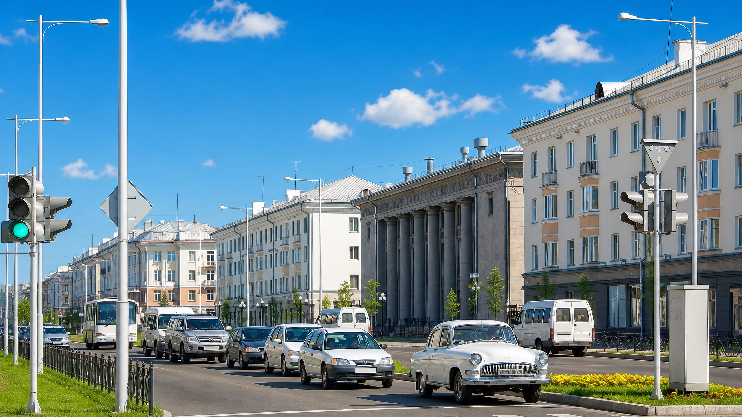 Stalin-era colonnaded building and neoclassical blocks lining a sunny avenue in Angarsk, Russia.