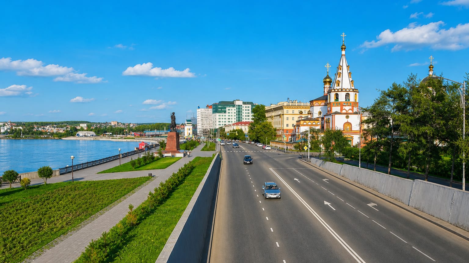 Irkutsk's Angara River embankment with the ornate Church of the Epiphany and city buildings under a clear blue sky