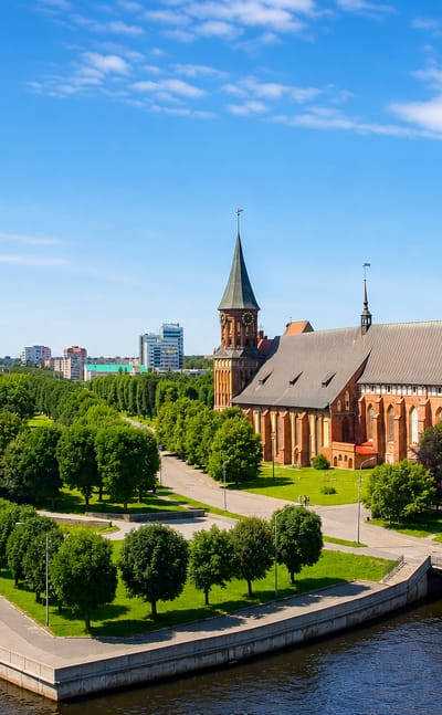 Kaliningrad Cathedral on Kant Island with its Gothic brick tower, surrounded by parkland along the Pregolya River.