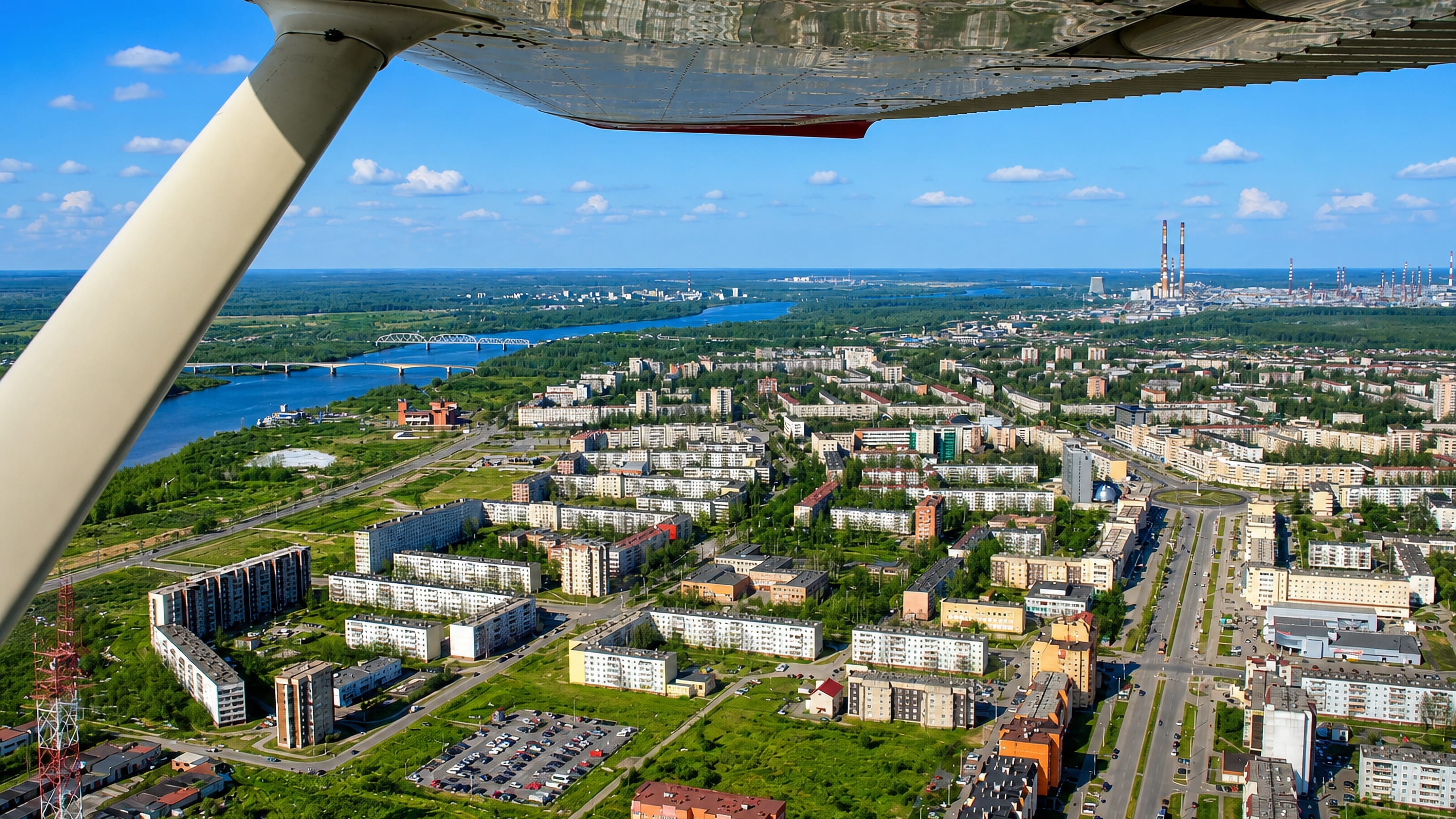 Aerial view over the river, apartment blocks and refinery stacks at Kirishi, Russia.