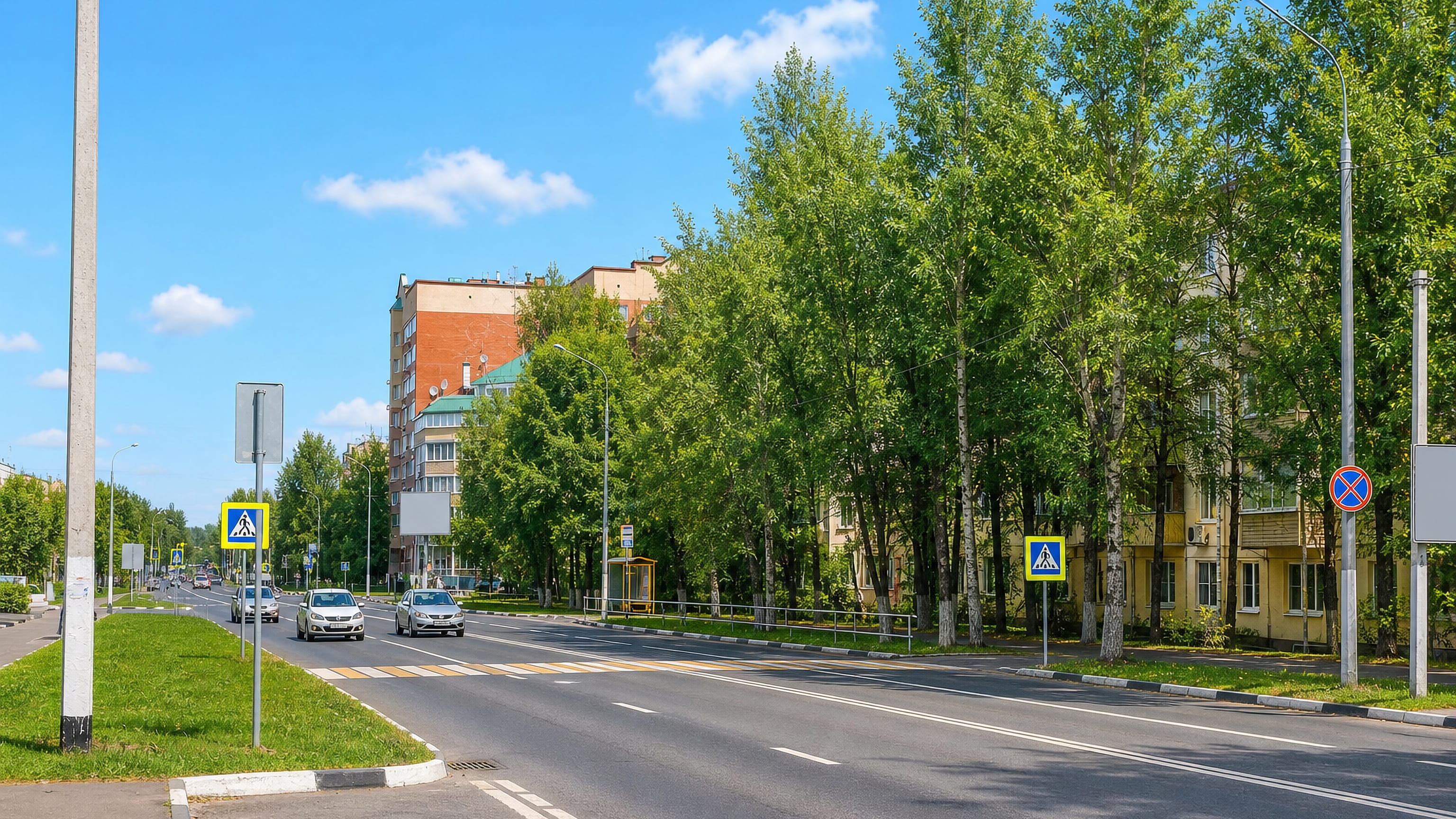 A tree-lined avenue past apartment blocks in Dolgoprudnyy, north of Moscow.
