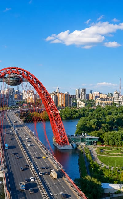 The red steel arch of the Zhivopisny Bridge with its suspended observation capsule spanning the Moskva River in Khoroshyovo-Mnyovniki, Moscow.