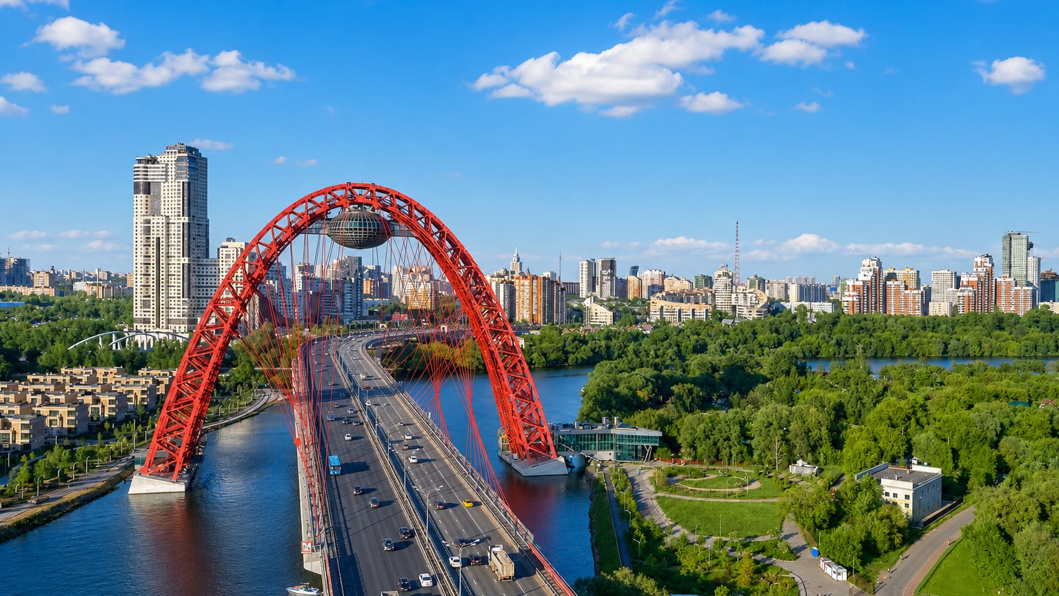 The red steel arch of the Zhivopisny Bridge with its suspended observation capsule spanning the Moskva River in Khoroshyovo-Mnyovniki, Moscow.