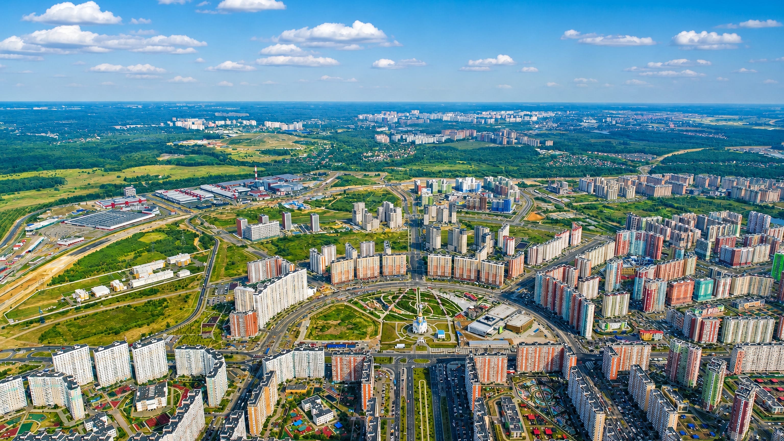 Aerial view over Nekrasovka's high-rise housing blocks ringing a circular park on Moscow's southeastern edge.