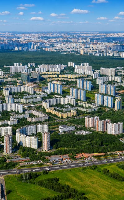 Aerial view of Yasenevo's Soviet-era apartment blocks bordered by dense forest on Moscow's southern edge.
