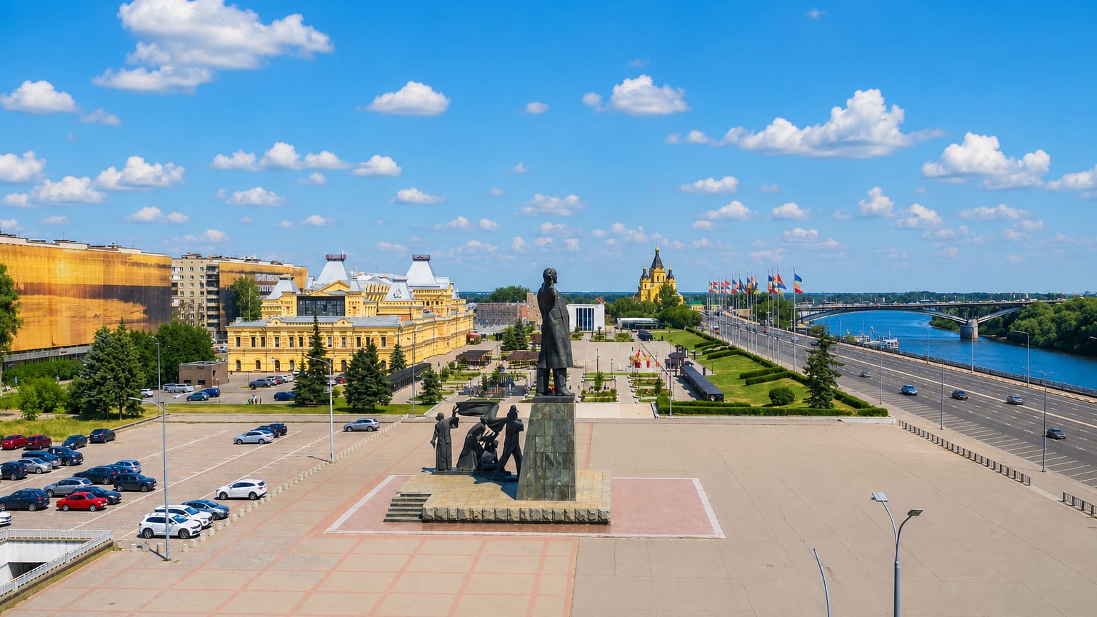 Kanavinsky District plaza in Nizhny Novgorod with a monument, historic fair building and the golden-domed Alexander Nevsky Cathedral by the river