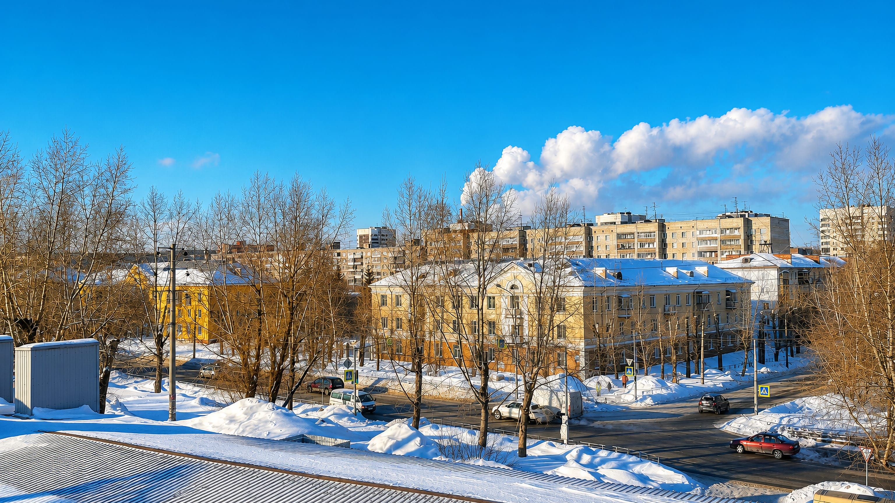 Snow-covered streets and low Soviet-era apartment blocks in Pervomaisky City District, Novosibirsk.