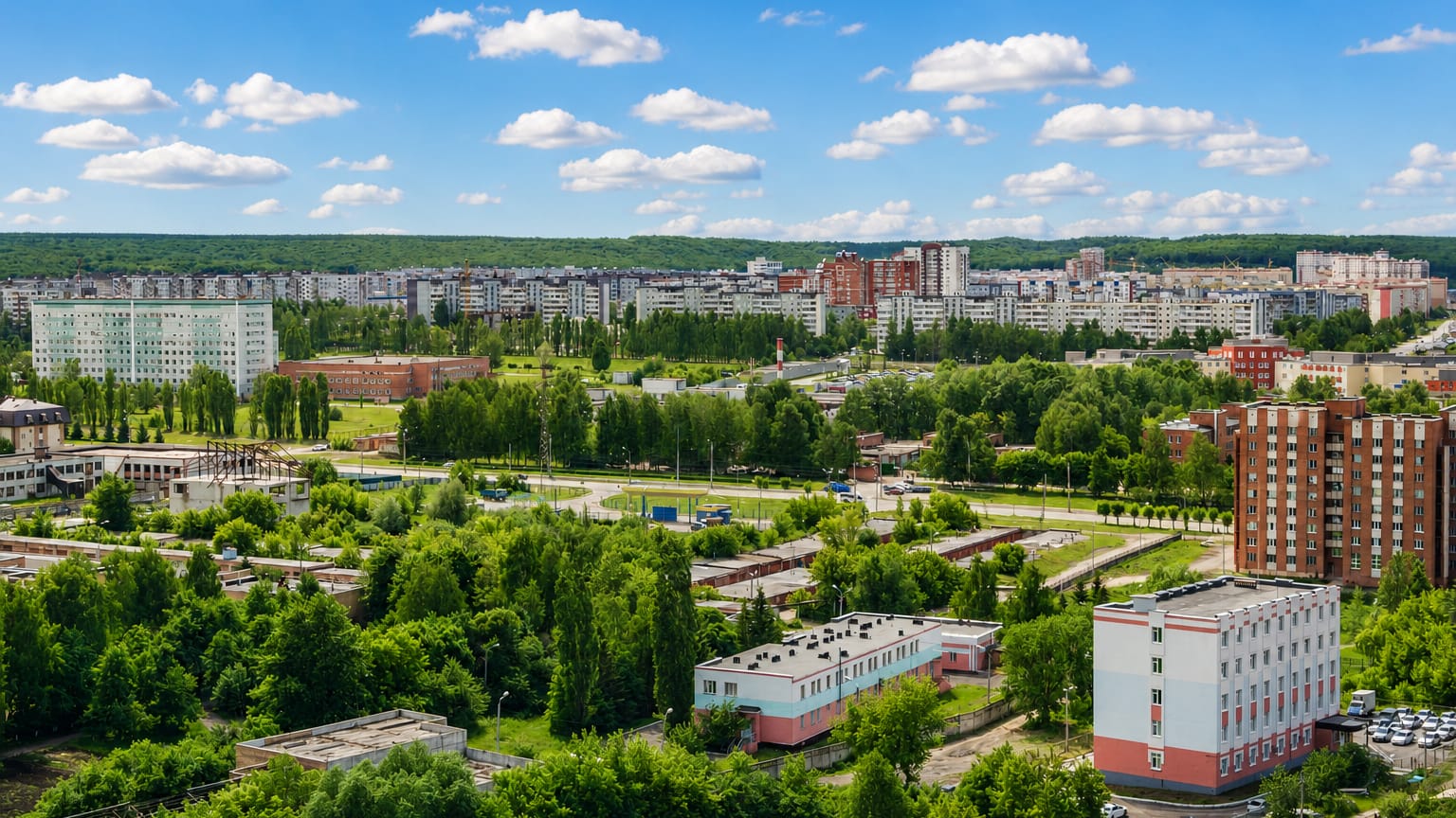 Aerial view of Penza's residential districts and greenery under a partly cloudy sky