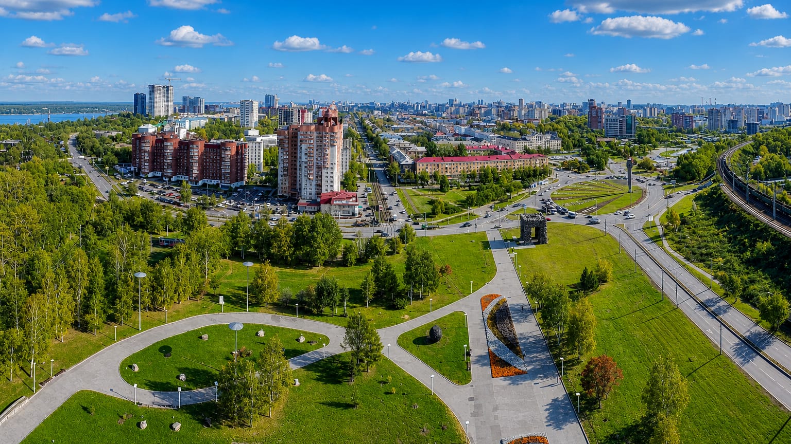 Aerial of a landscaped park, boulevards and apartment towers with the Kama River beyond in Perm, Russia