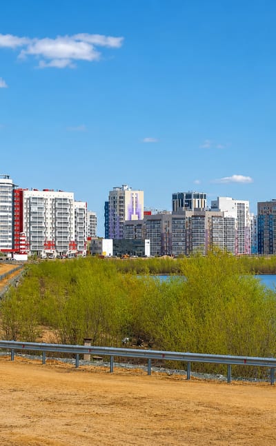 Riverside district of Yakutsk with modern mid-rise apartment blocks fronting a sandy foreshore along the Lena River.