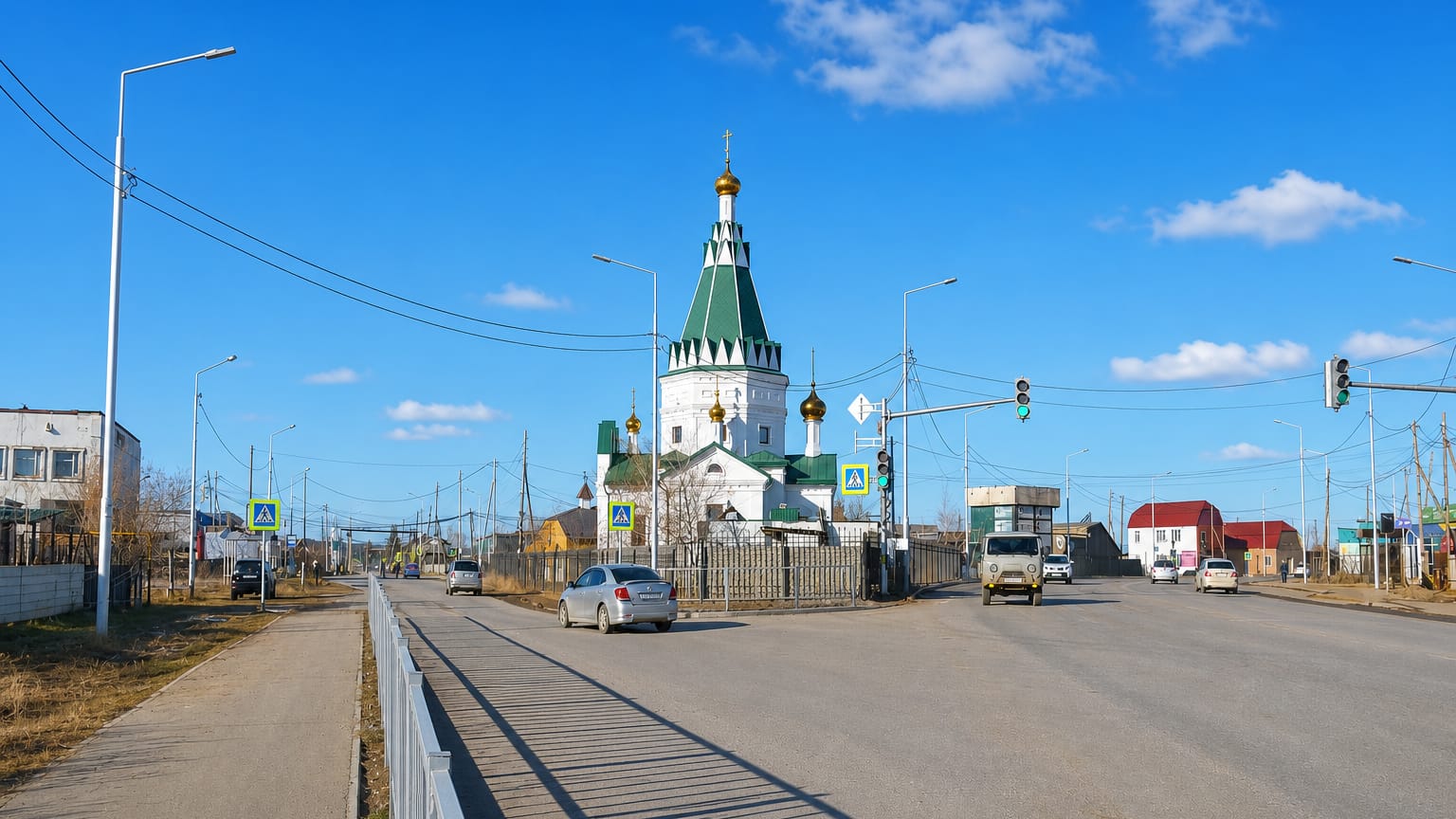 Street in Markha, Yakutsk, with a green-roofed white Orthodox church and wide roadway