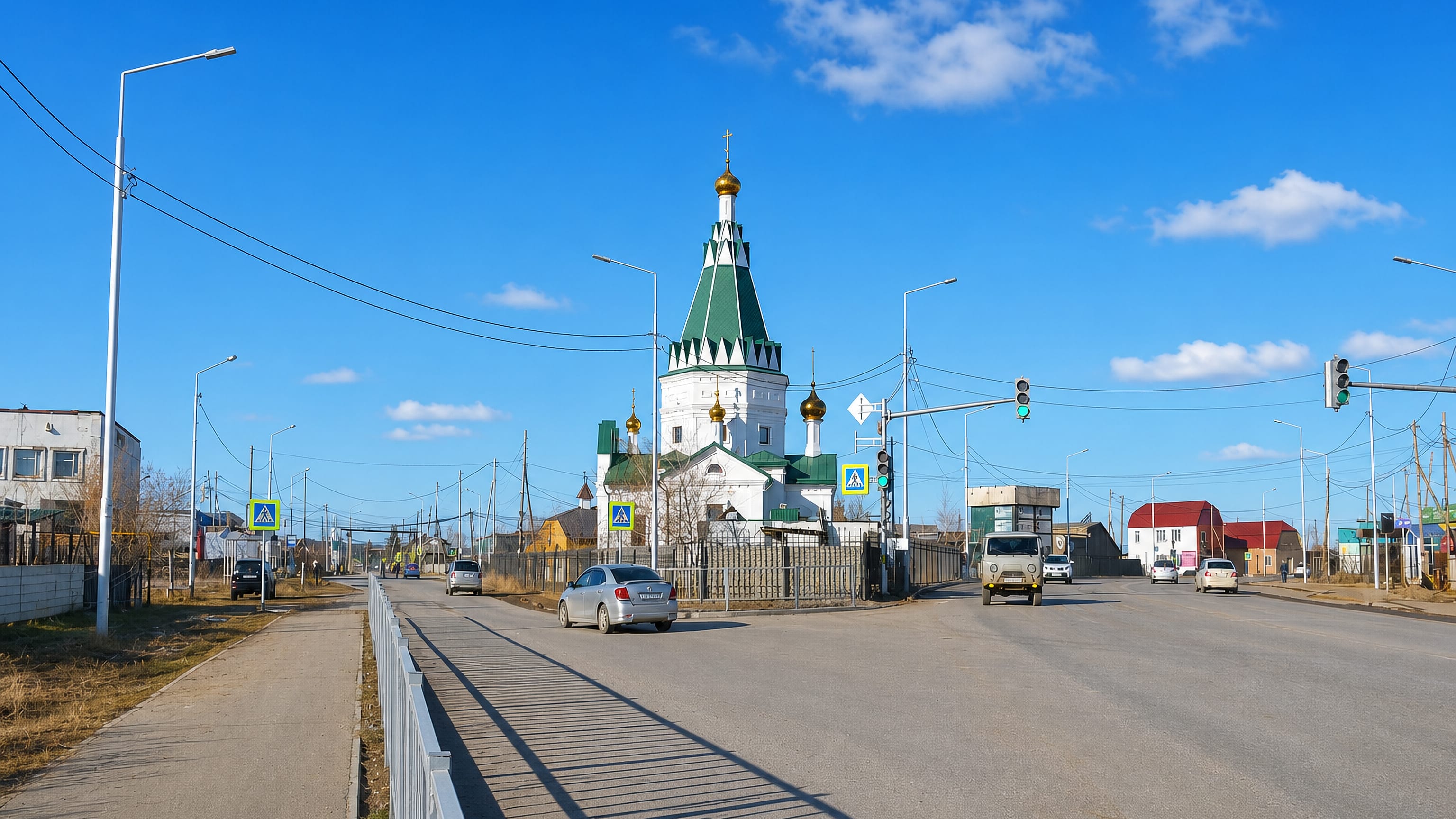 Street in Markha, Yakutsk, with a green-roofed white Orthodox church and wide roadway