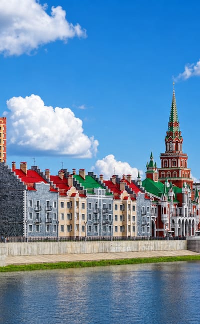 Yoshkar-Ola's Bruges Embankment, Russia, lined with colourful Flemish-style buildings along the river.