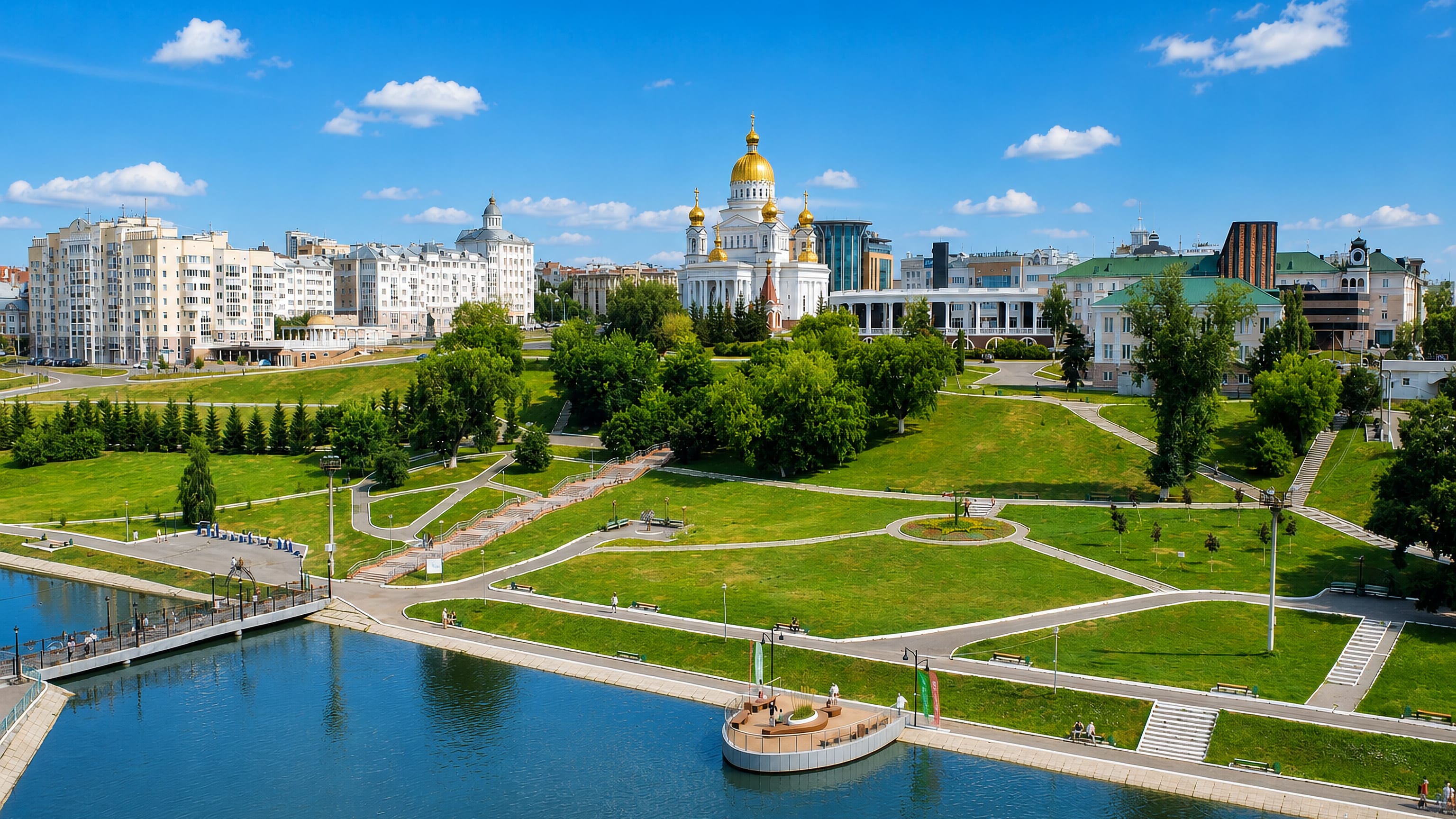 Gold-domed Orthodox cathedral above the terraced riverside park and embankment in Saransk, Russia.