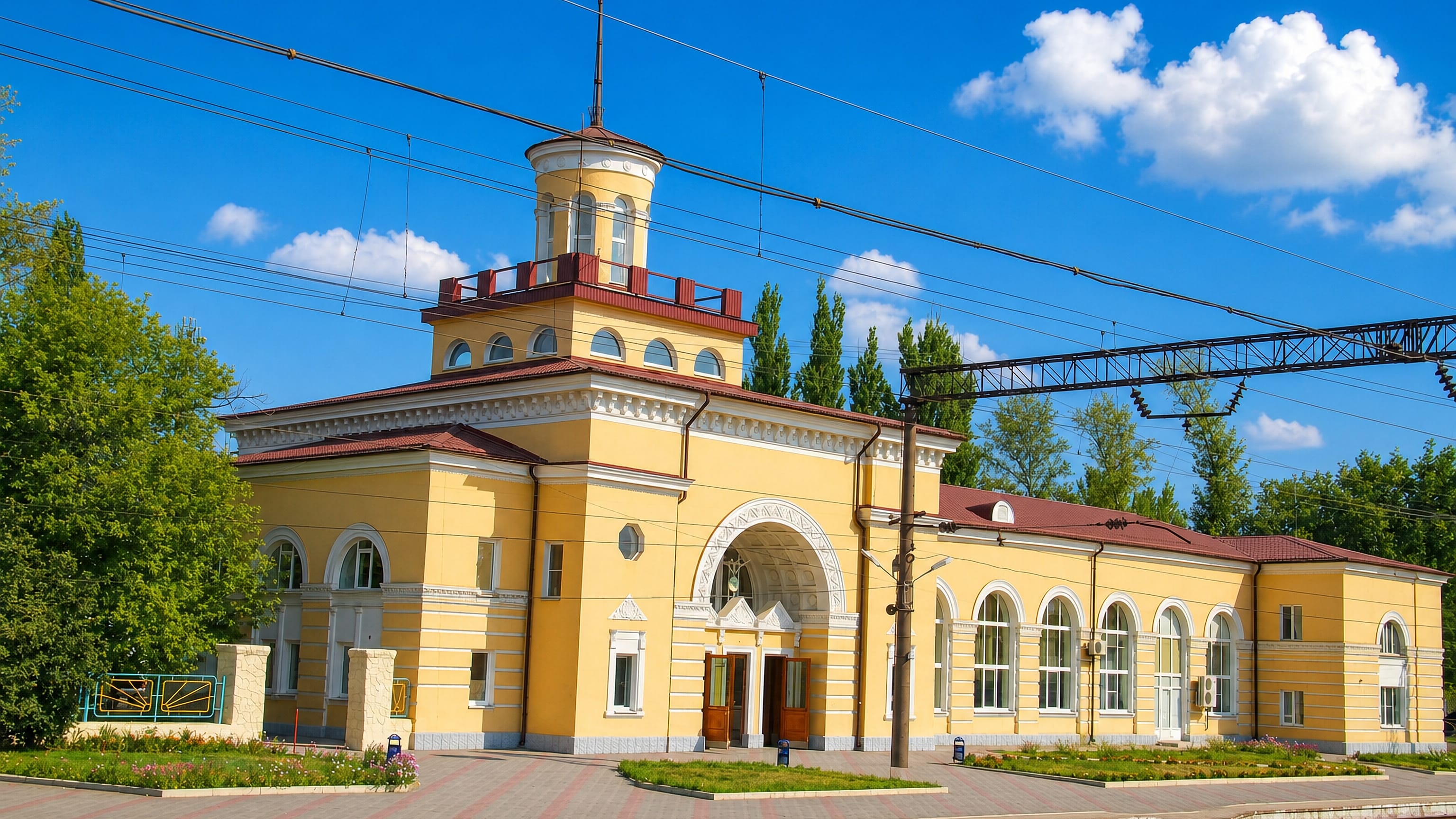 The yellow railway station building with its lantern tower in Kamensk-Shakhtinsky, Russia.