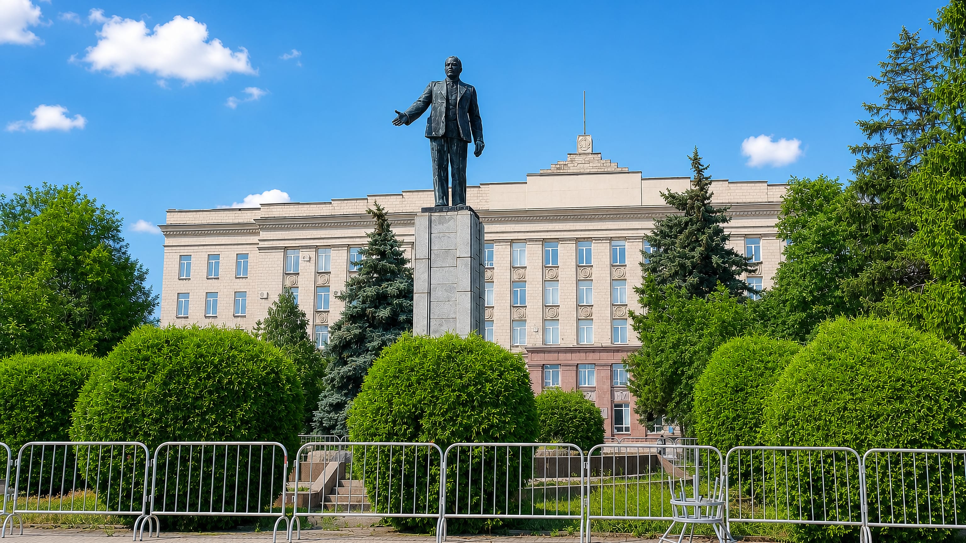 Lenin monument standing before a Soviet-era administration building on a central square in Shakhty, Russia.