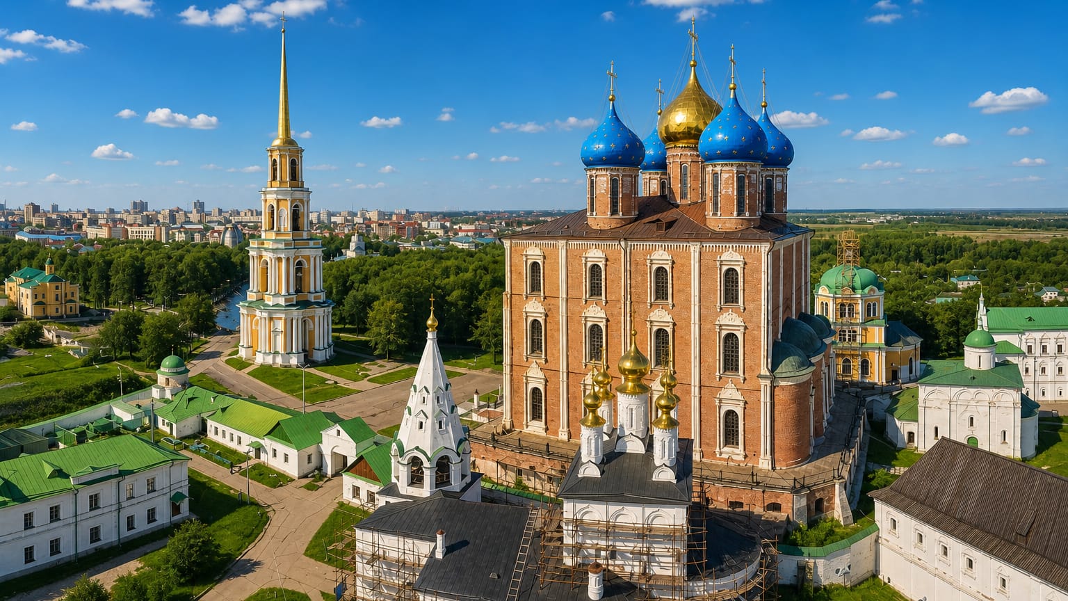 Aerial view of the Ryazan Kremlin with its red-brick cathedral, blue domes and tall bell tower.