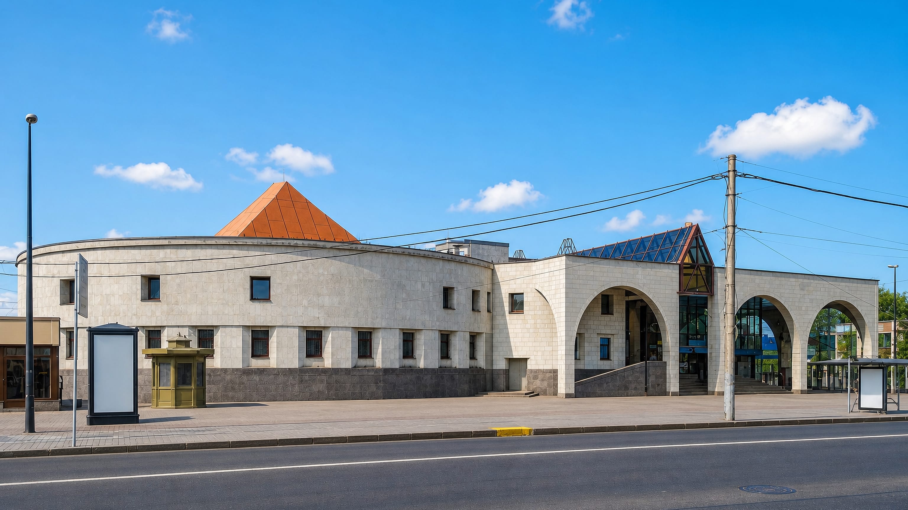 Staraya Derevnya metro station in Saint Petersburg, its stone rotunda and copper pyramid roof beside the road