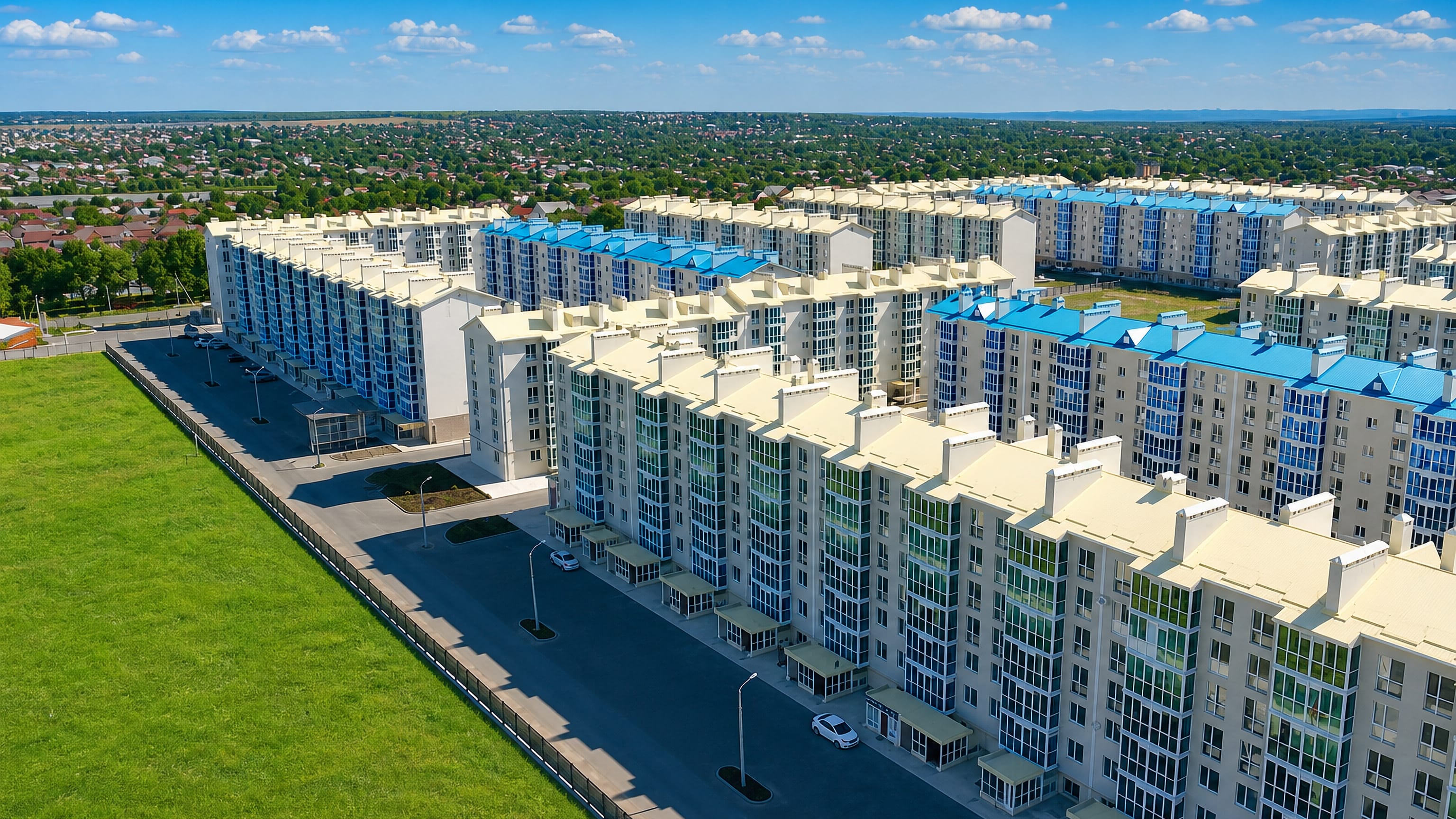New white-and-blue apartment blocks line wide streets on the green edge of Mikhaylovsk, Stavropol Krai.