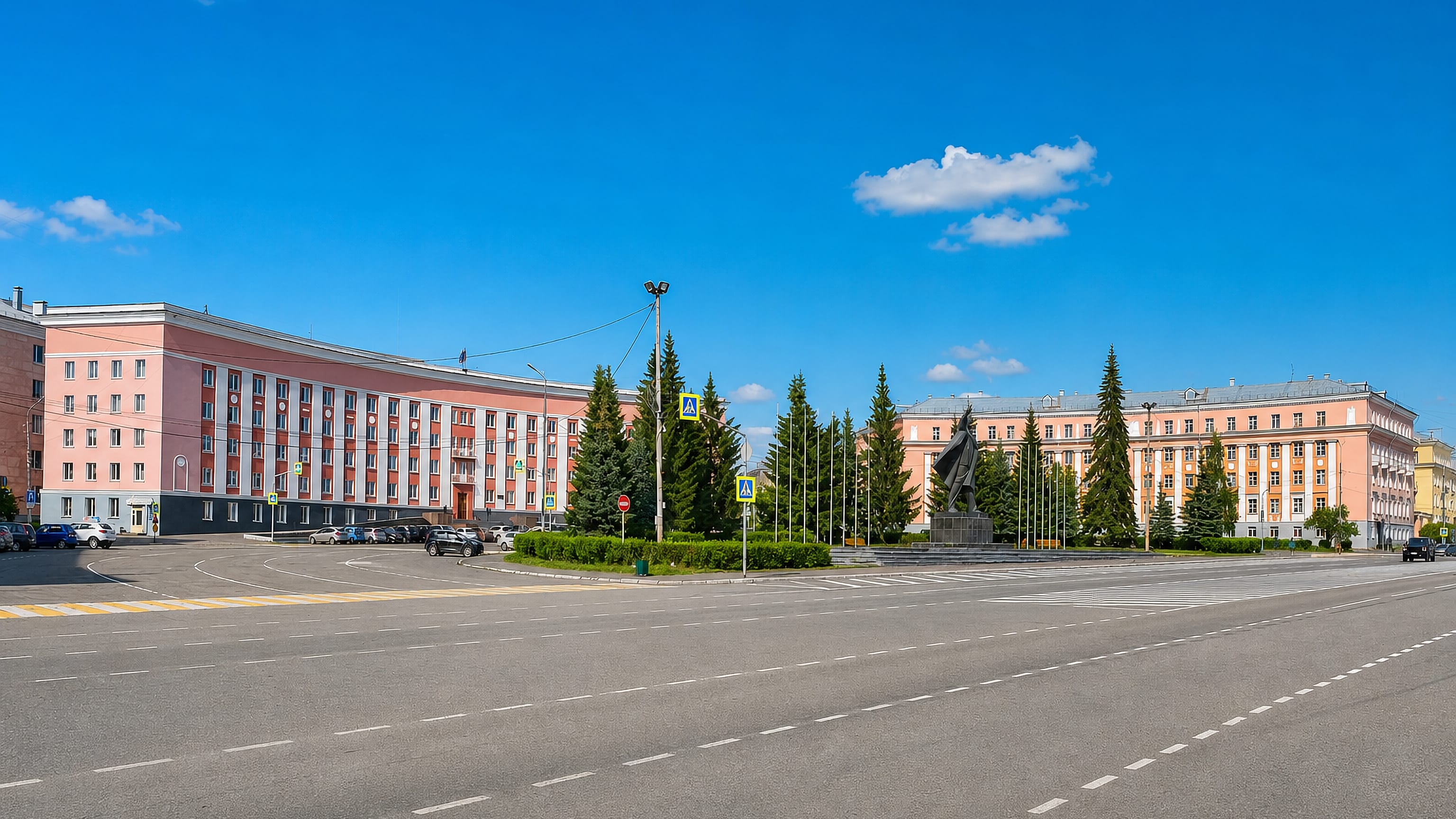 Stalin-era salmon-pink civic buildings and a monument on the central square of Krasnoturinsk, Russia