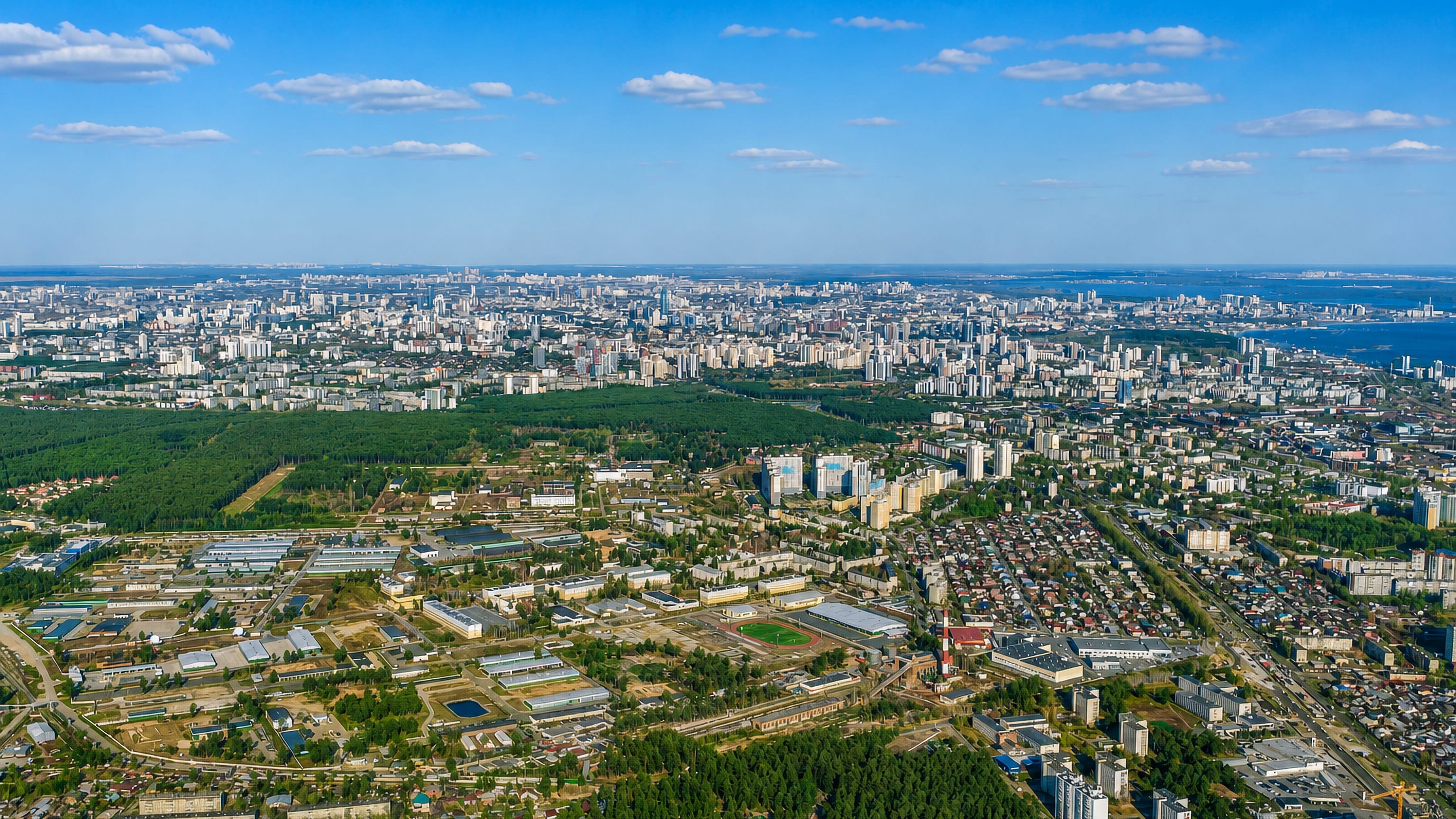 Aerial view over the forests and apartment blocks of Chkalovski district toward central Yekaterinburg.