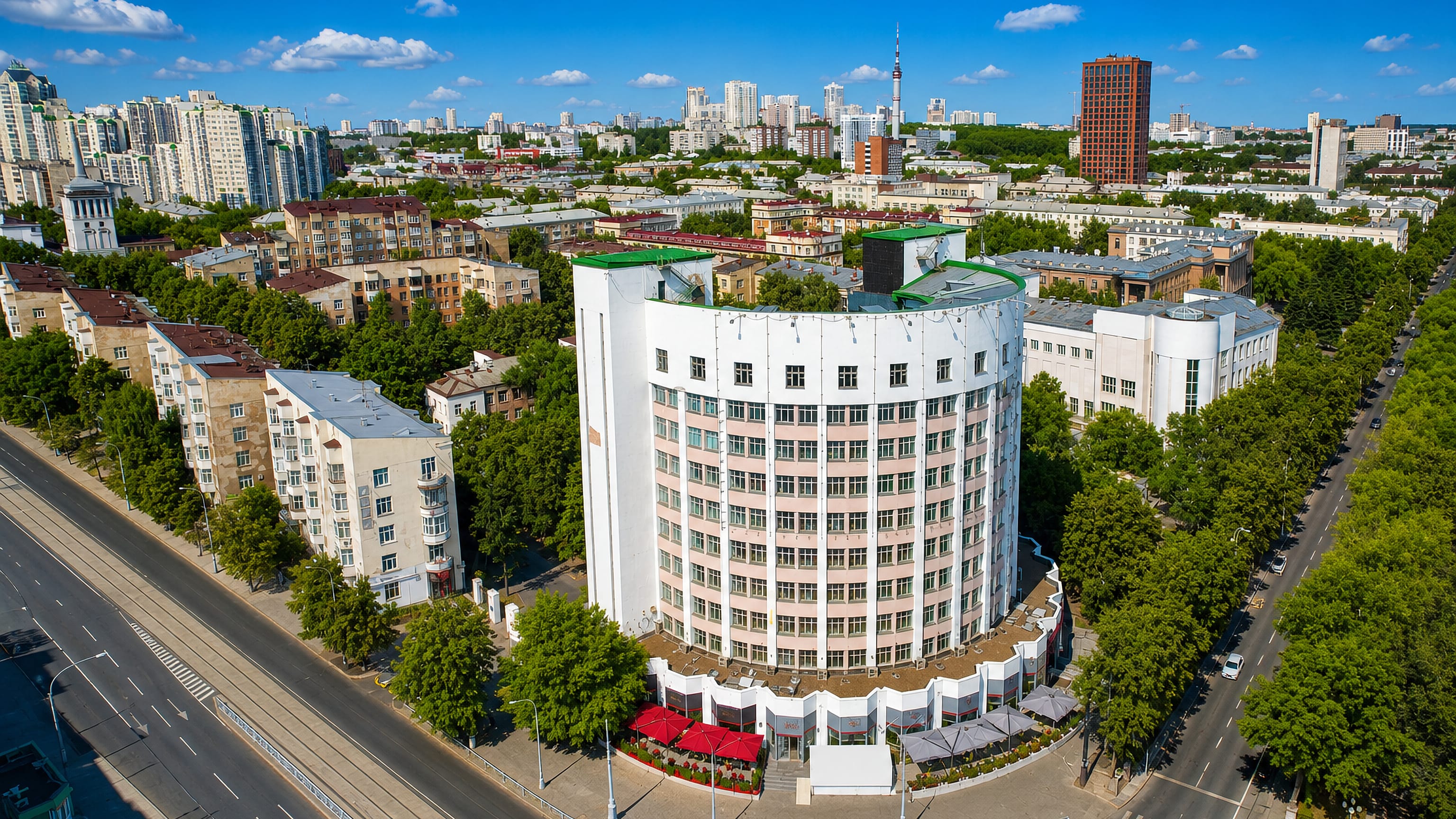Curved white constructivist block and tree-lined avenue in Gorodok Chekistov, Yekaterinburg.