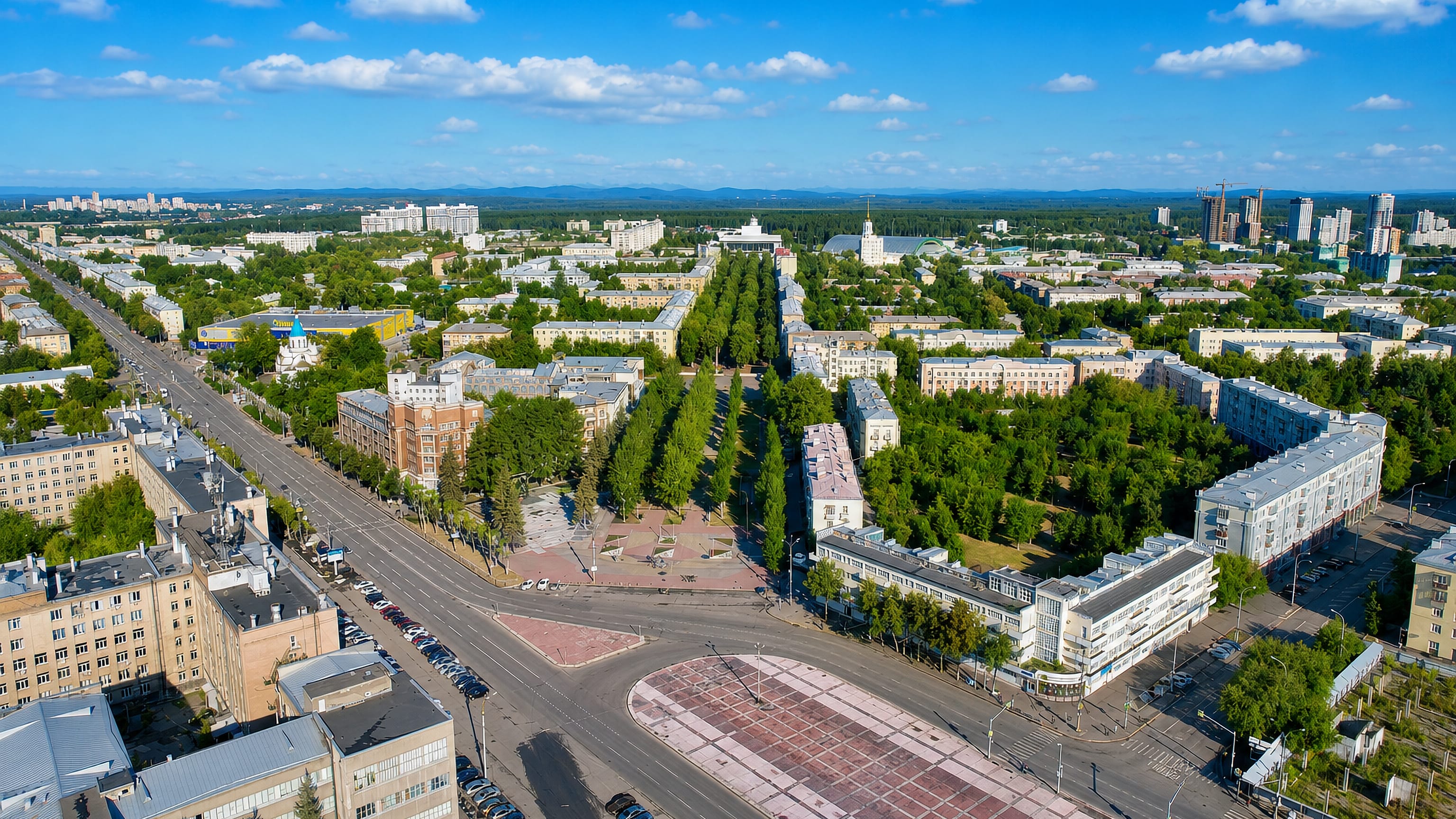 Aerial view over Uralmash in Yekaterinburg, showing radial avenues, a tree-lined boulevard and Stalinist blocks.