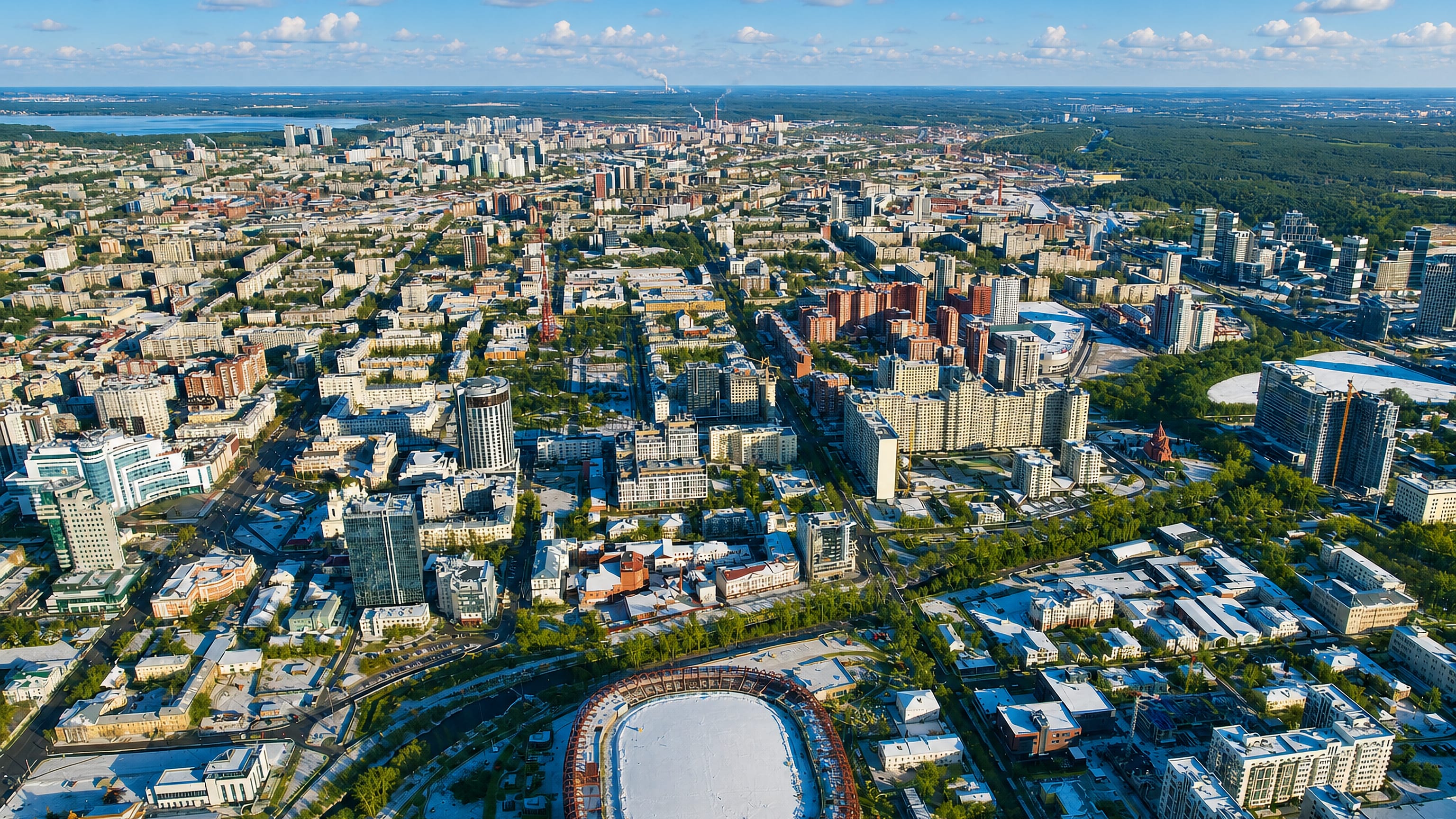 Aerial view over Yekaterinburg's Oktyabrski district, with apartment blocks, offices and a large stadium bowl.