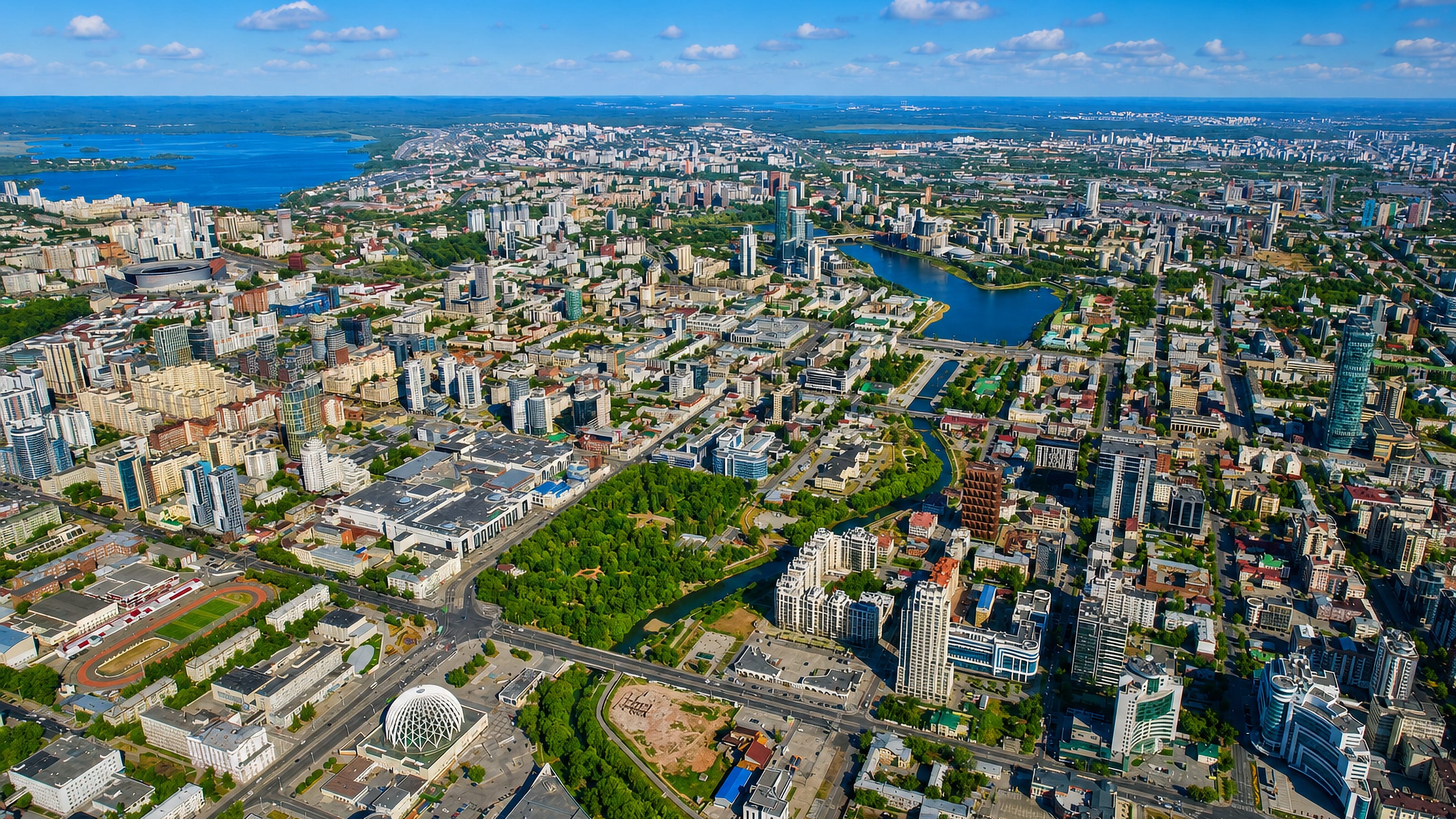 Aerial view over central Yekaterinburg with the city pond, high-rise towers and the circus dome