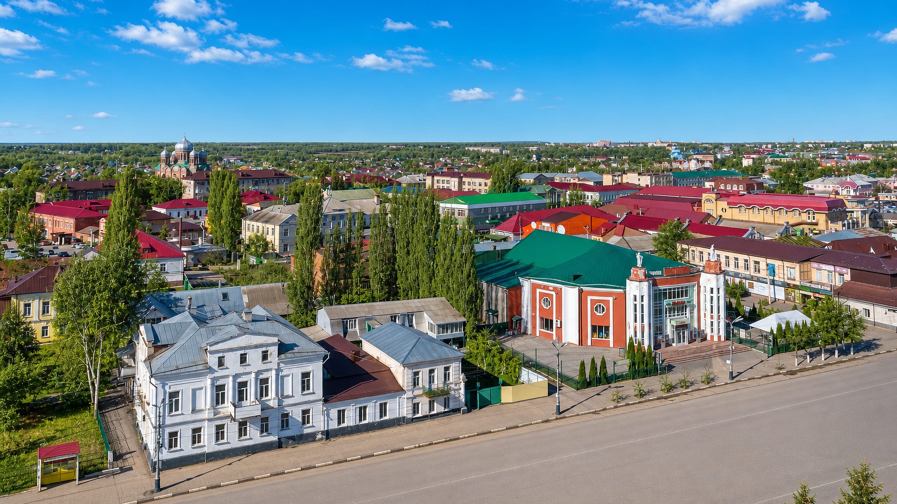 Low-rise centre of Michurinsk, Russia, with merchant houses, a columned theatre and distant church domes.