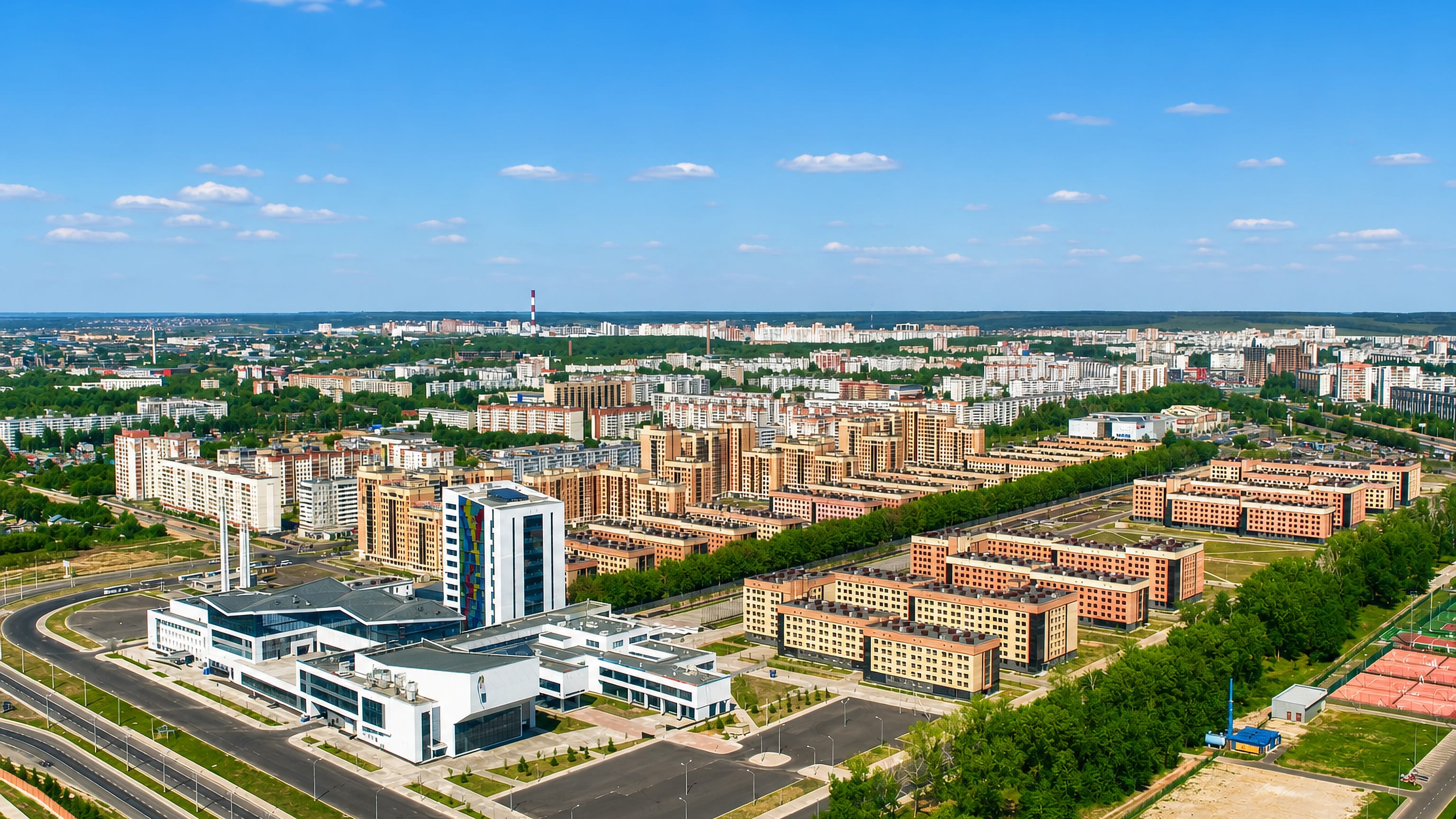 Aerial view of Kazan's Universiade Village, rows of matching residential blocks around a modern sports centre