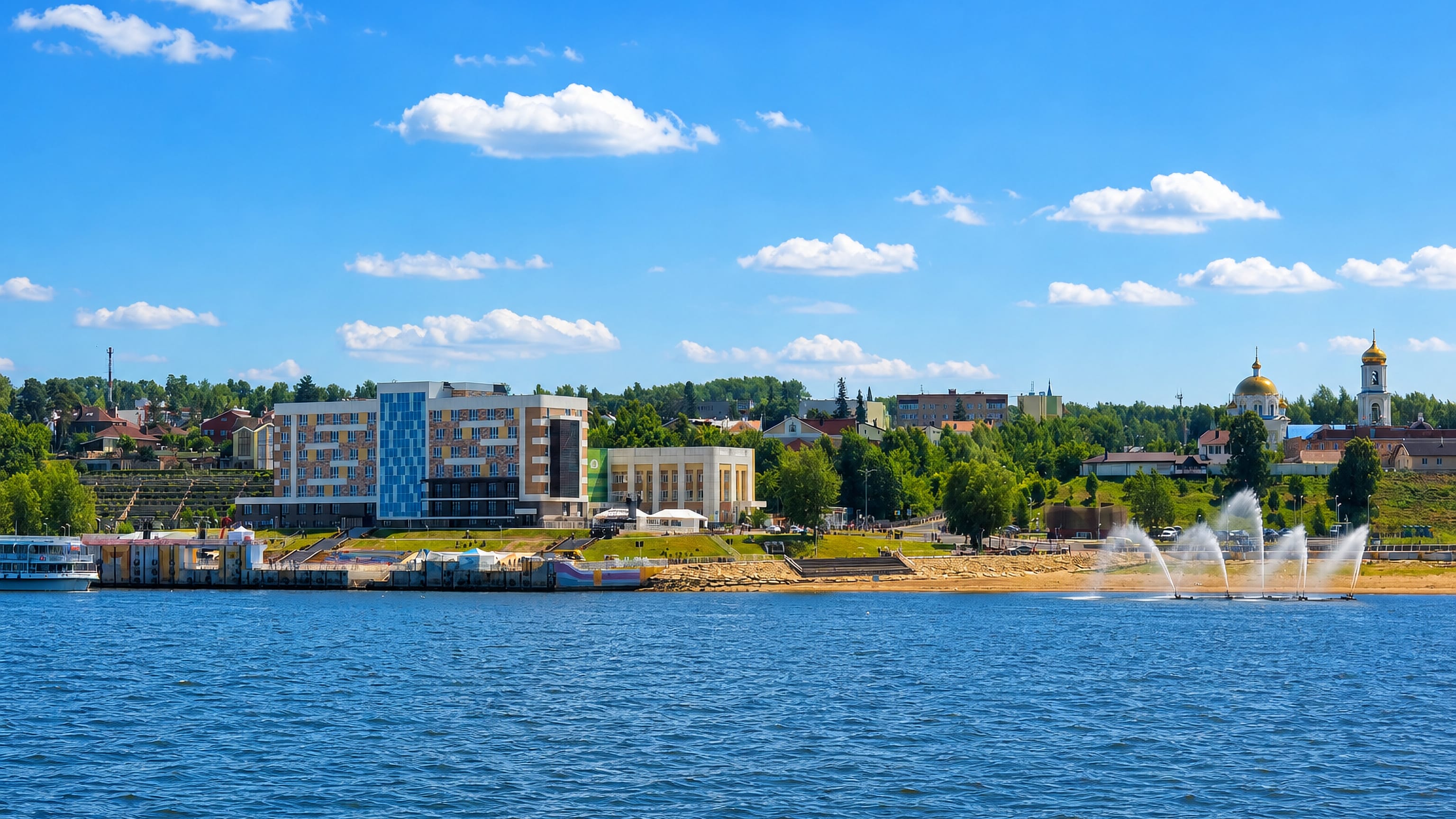 Riverfront at Nizhnekamsk with a golden-domed Orthodox church, colourful mid-rise blocks and water fountains
