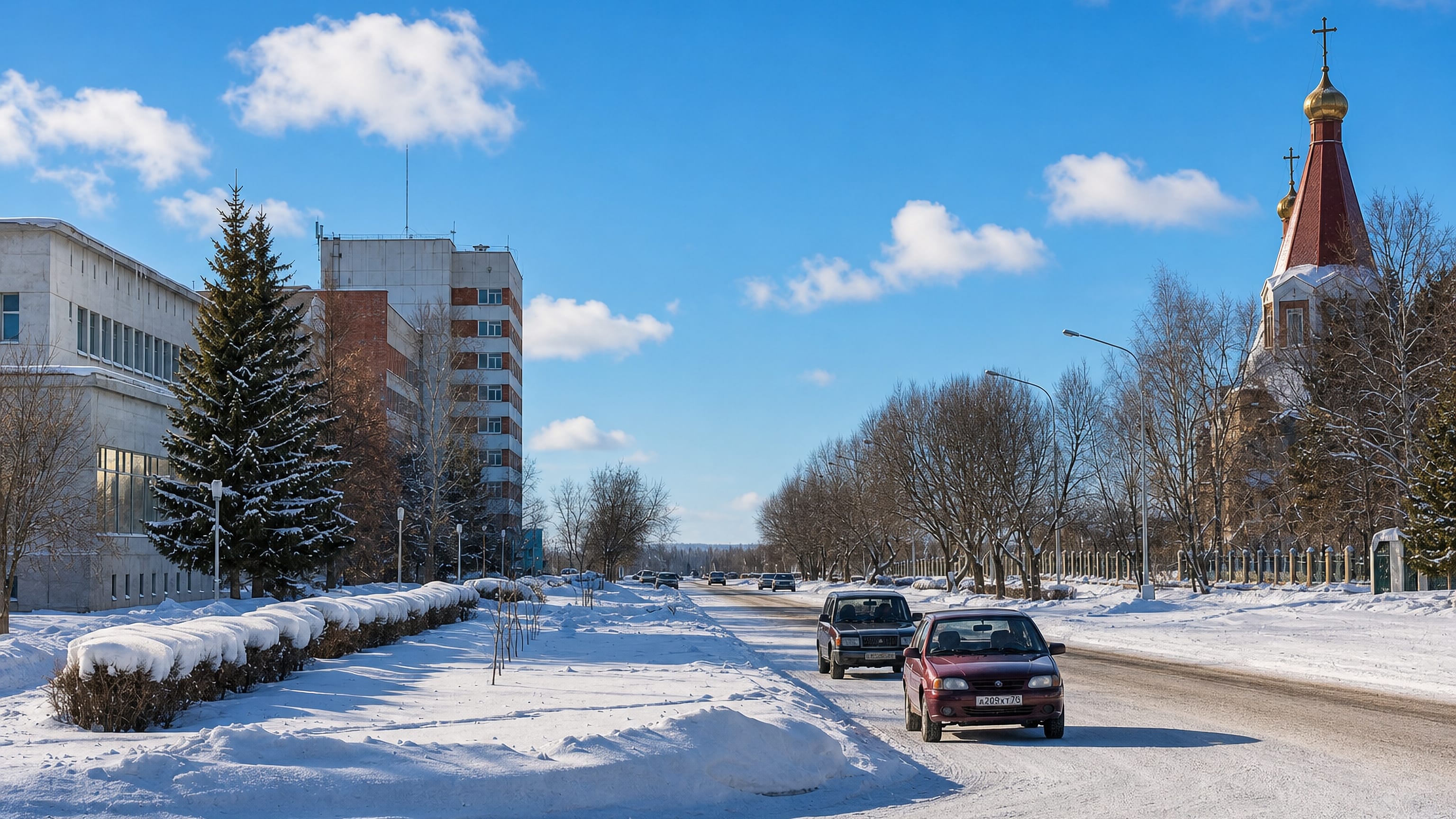 Snow-covered boulevard in Seversk, Russia, lined with Soviet-era apartment blocks and an Orthodox church.