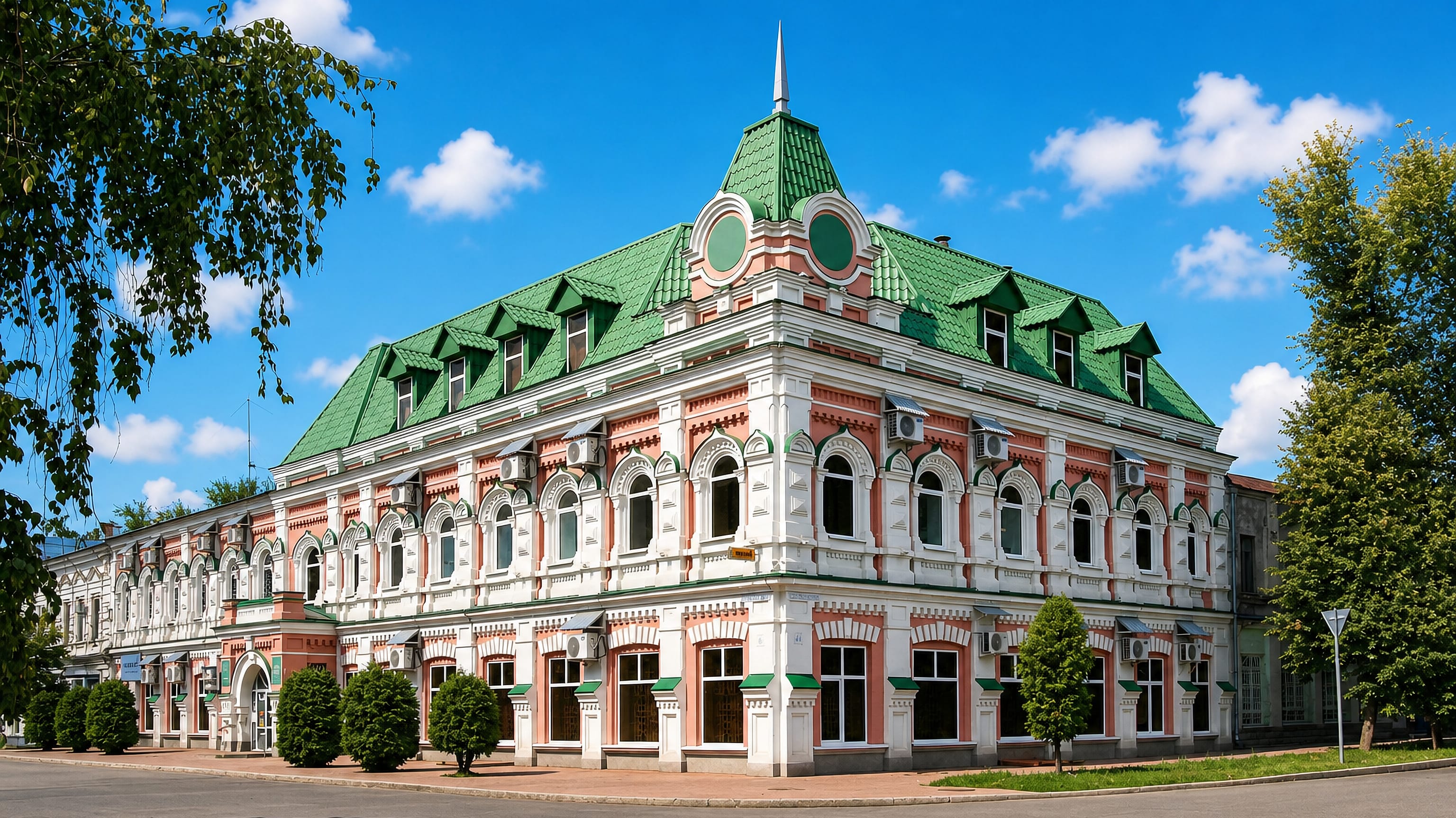 Restored merchant house with a green turreted roof on a corner in Dimitrovgrad, Ulyanovsk Oblast.