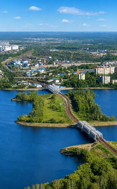 Aerial view of Voronezh with railway bridges spanning the wide reservoir and riverside districts.