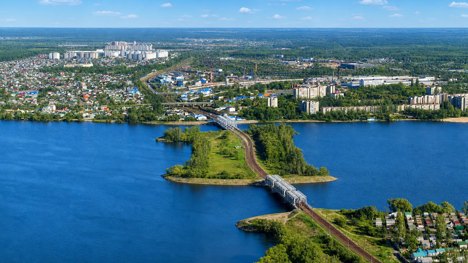 Aerial view of Voronezh with railway bridges spanning the wide reservoir and riverside districts.