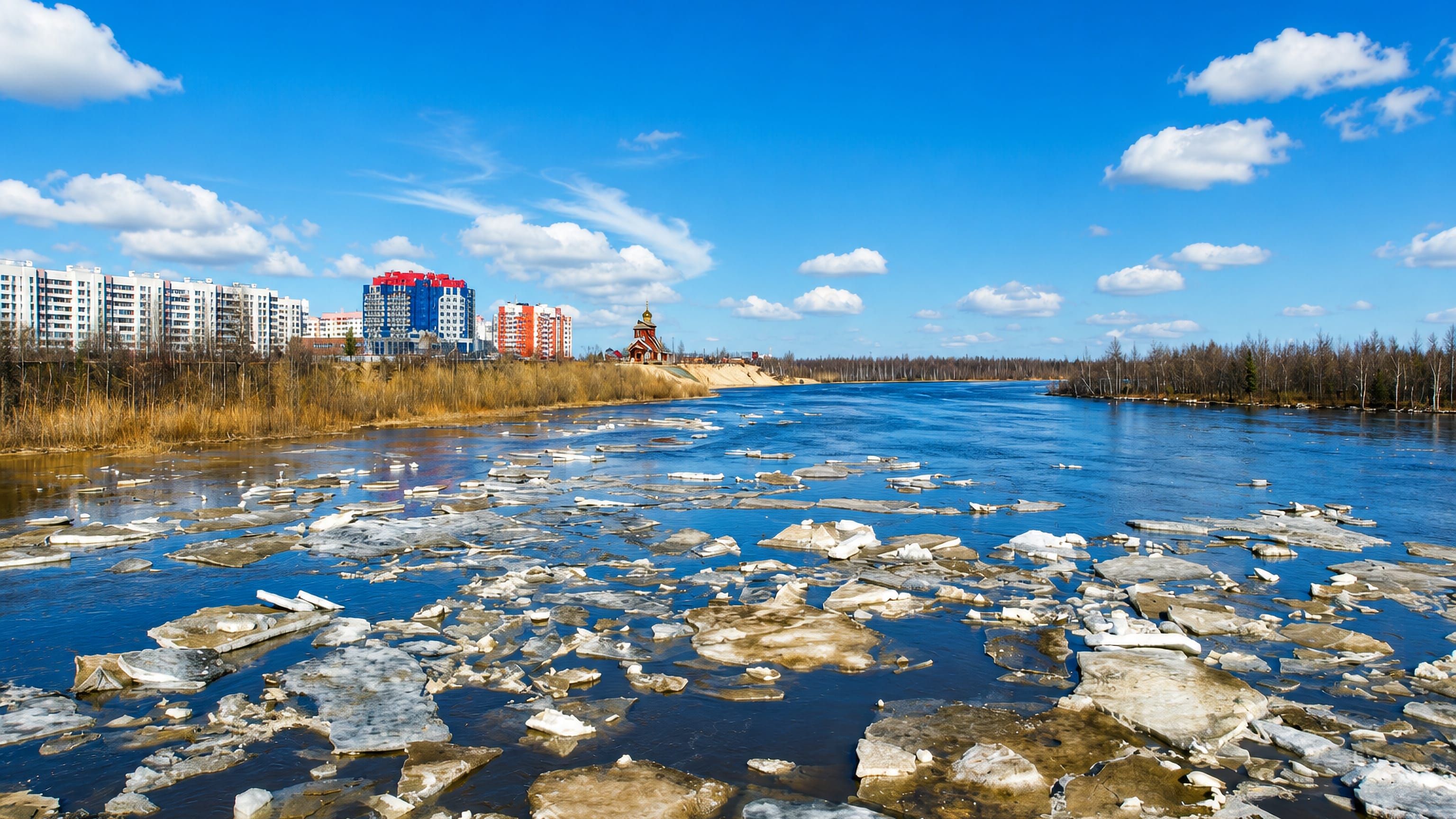 Ice drifting down the river past Novyy Urengoy's colourful apartment blocks and a small wooden Orthodox church.