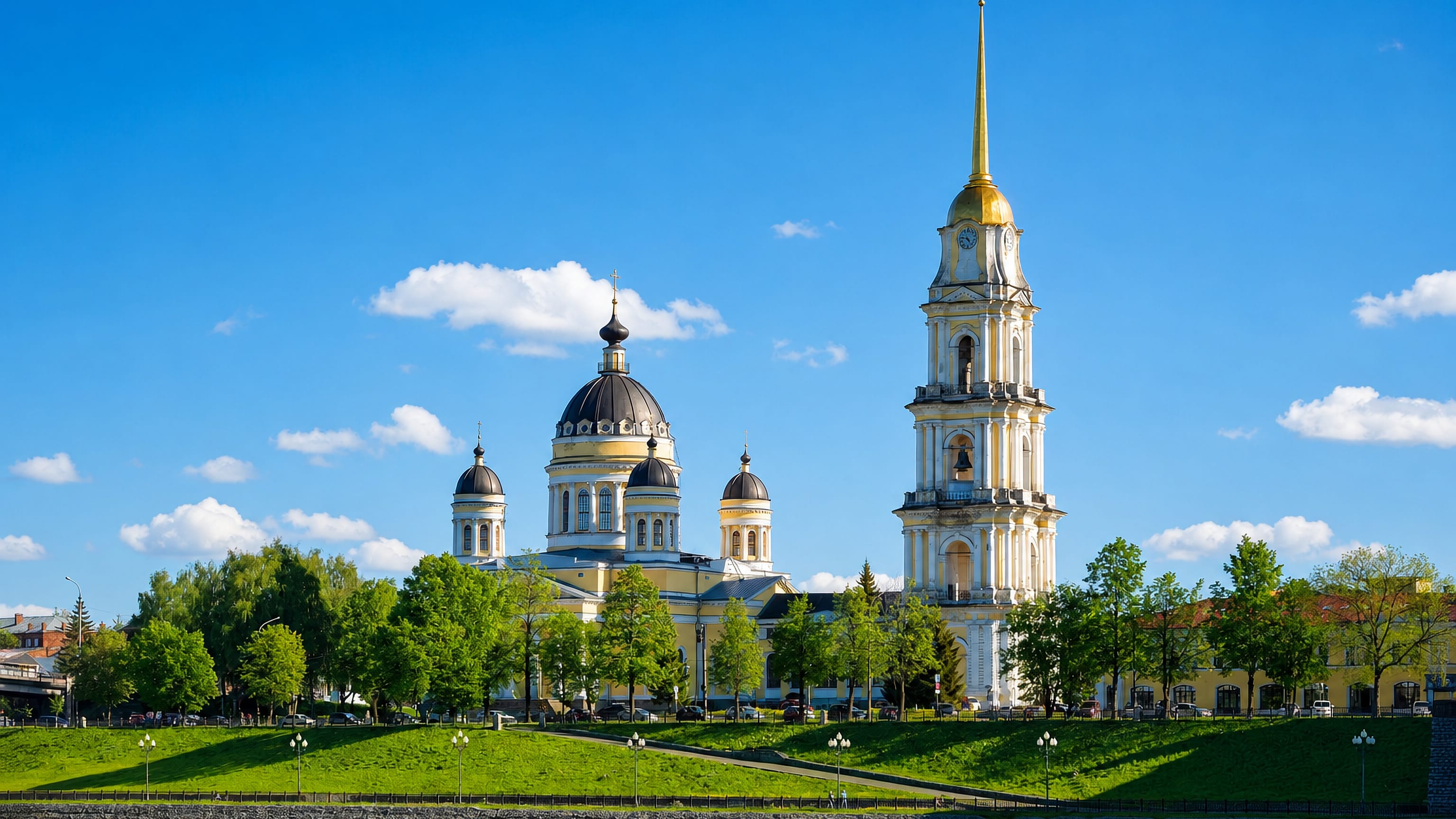 Rybinsk's Transfiguration Cathedral and its tall gold-spired bell tower above the green Volga embankment.